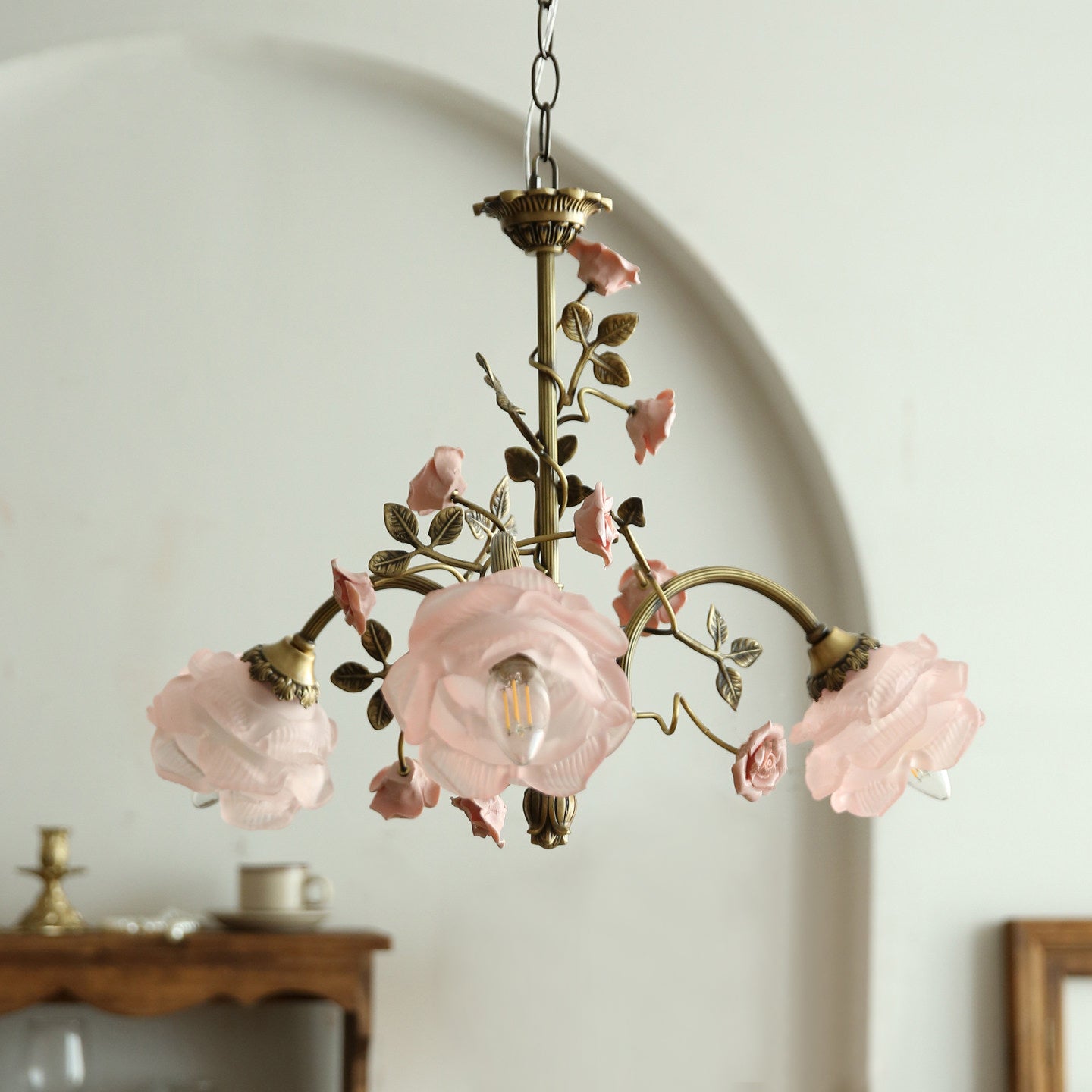 The Rosalie Chandelier illuminated, casting a warm and inviting glow.