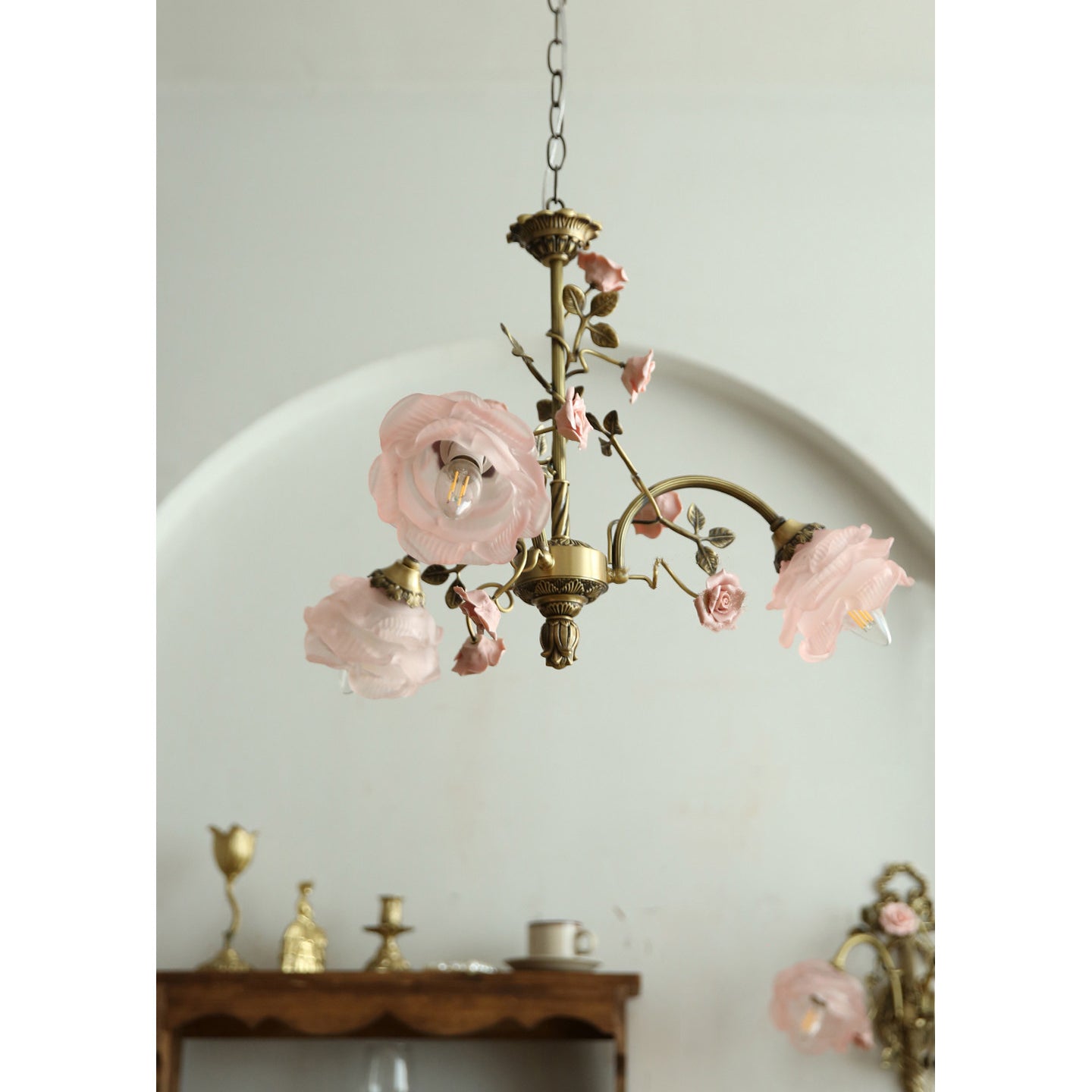 Close-up on a single glass rose lampshade, showing its sculpted detail.