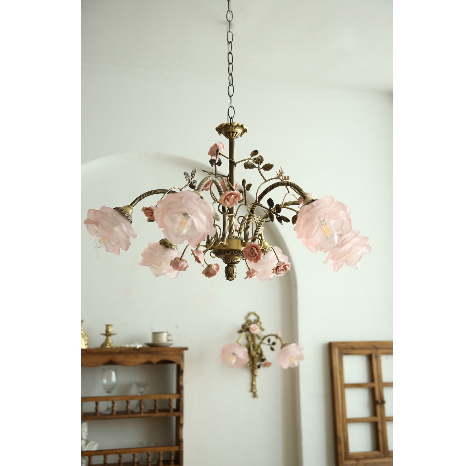 The chandelier's hanging chain and ceiling canopy in an antique brass finish.