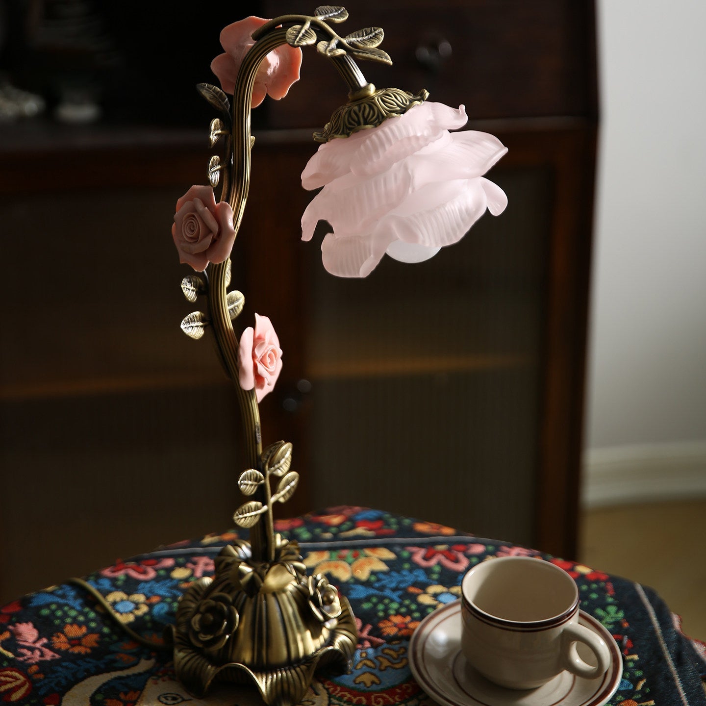 The Rosalie lamp shown on a bedside table, providing ambient light.