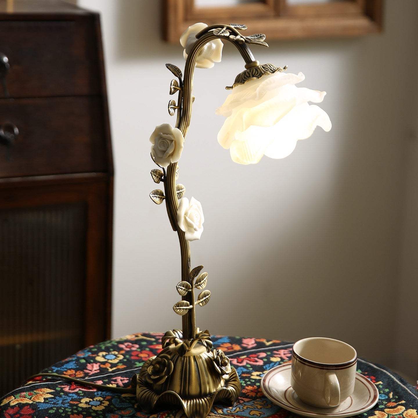 Angled view displaying the depth of the floral arrangement and glass shade.