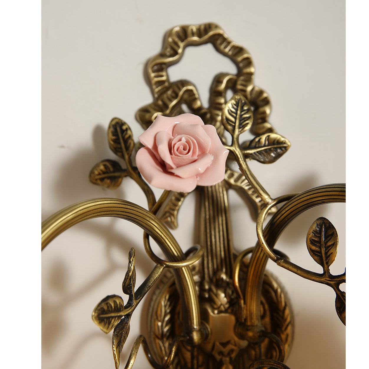 Unlit view of the pink glass shades, showing their delicate floral shape.