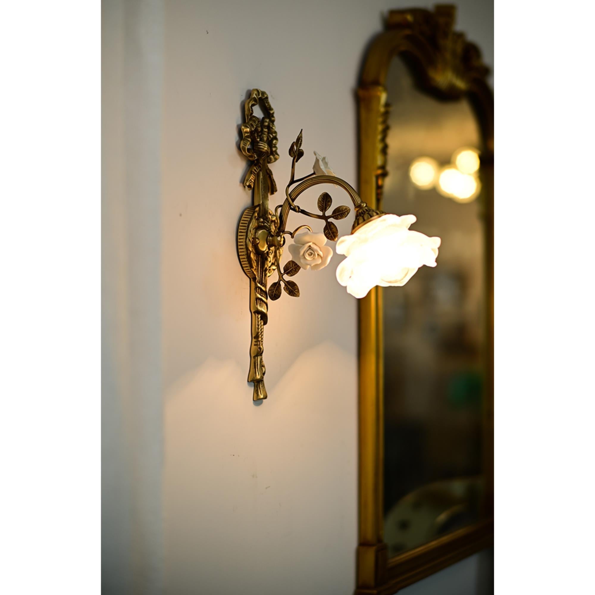 Close-up of the junction between the glass shade and brass body.