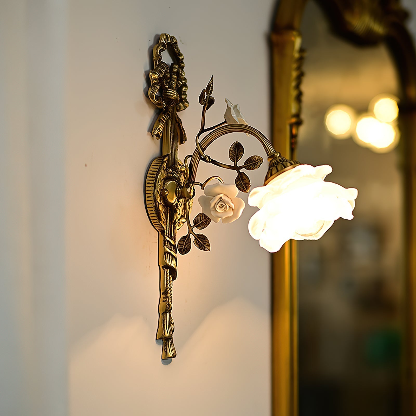 Front view of the Rosalie Floral Wall Lamp with its white glass shade.