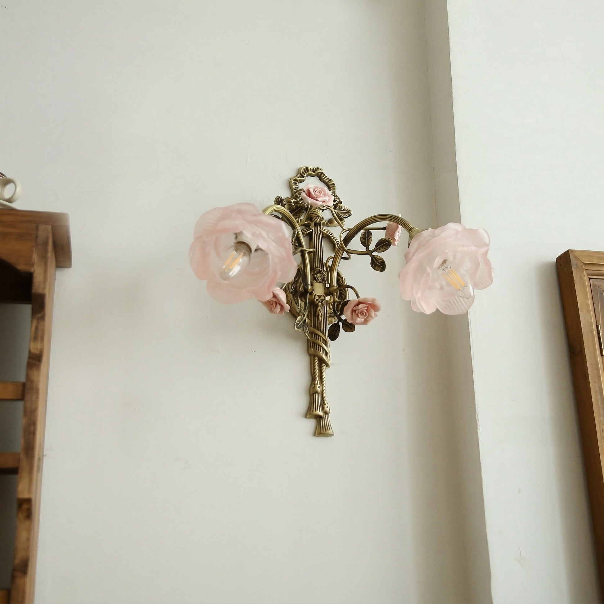 Close-up of the translucent pink glass rose shade on the Rosalie sconce.