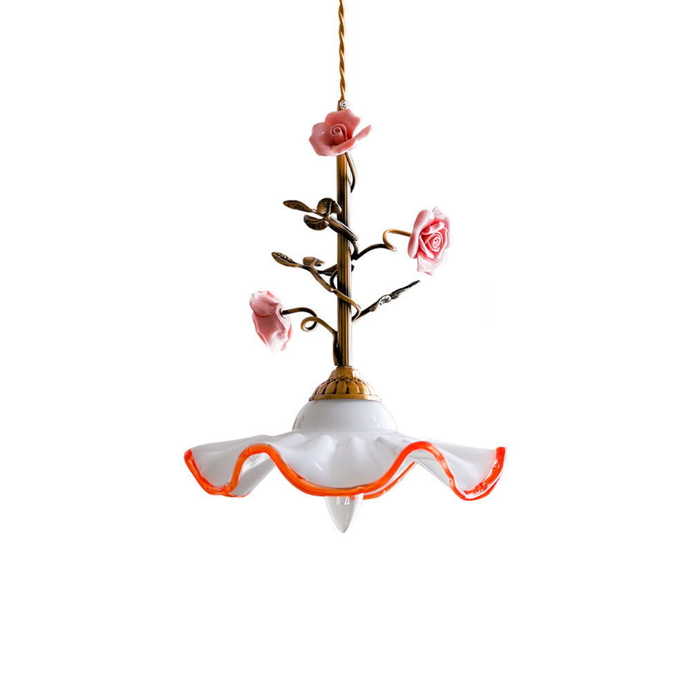 Close-up on the golden butterfly accent fluttering beneath the ceramic roses.