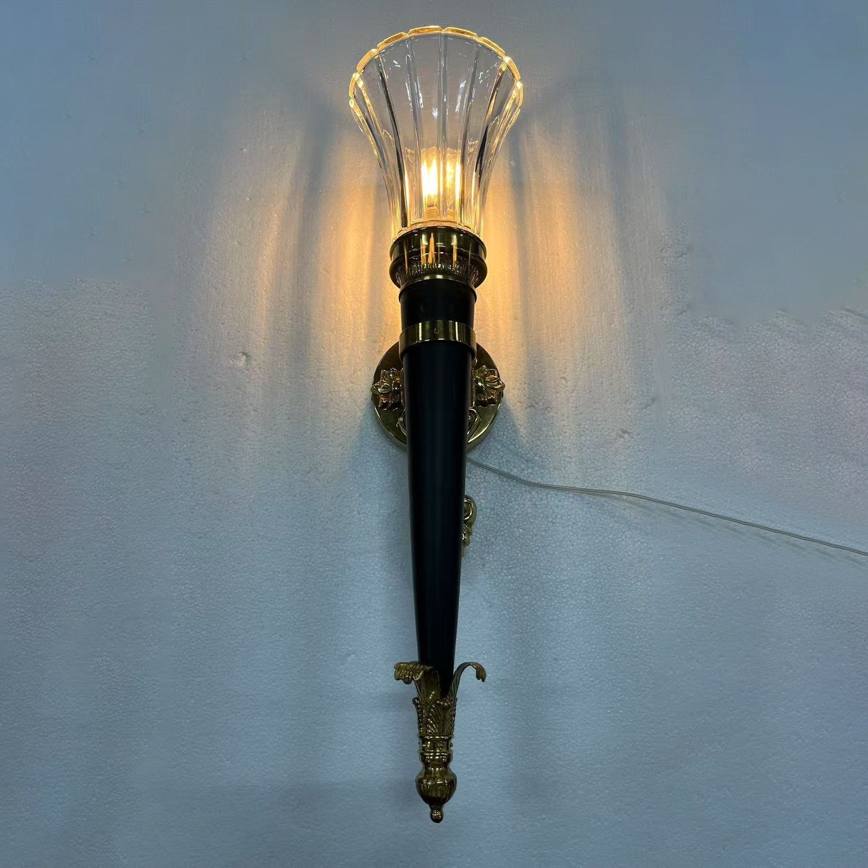 Rosalinda Torch Wall Lamp with a vintage-style bulb.