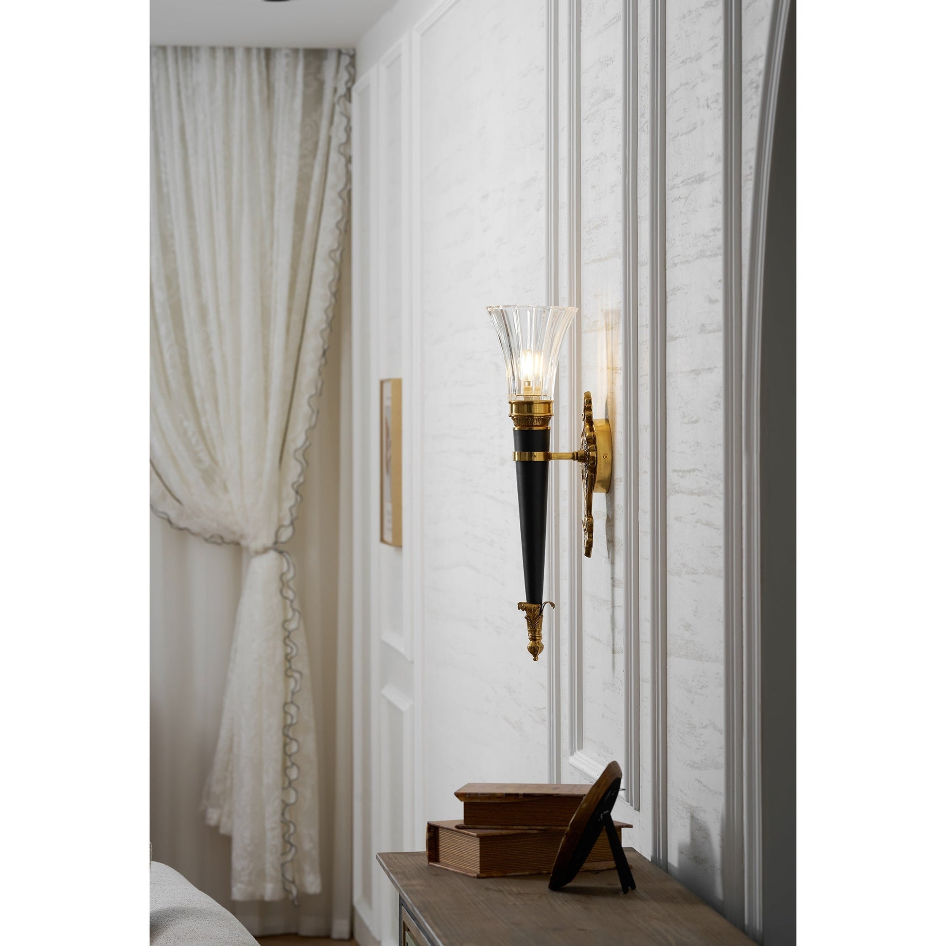 A pair of Rosalinda Torch Wall Lamps flanking a piece of art.