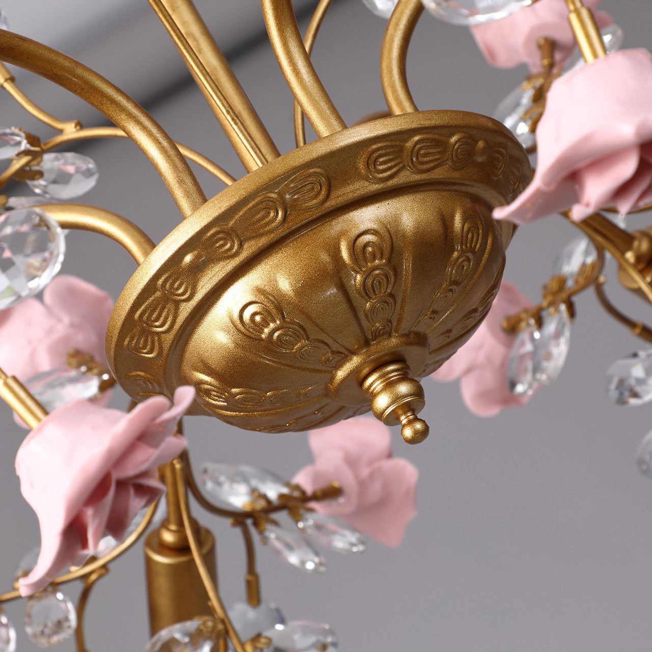 The chandelier unlit, showing the craftsmanship of the ceramic flowers.