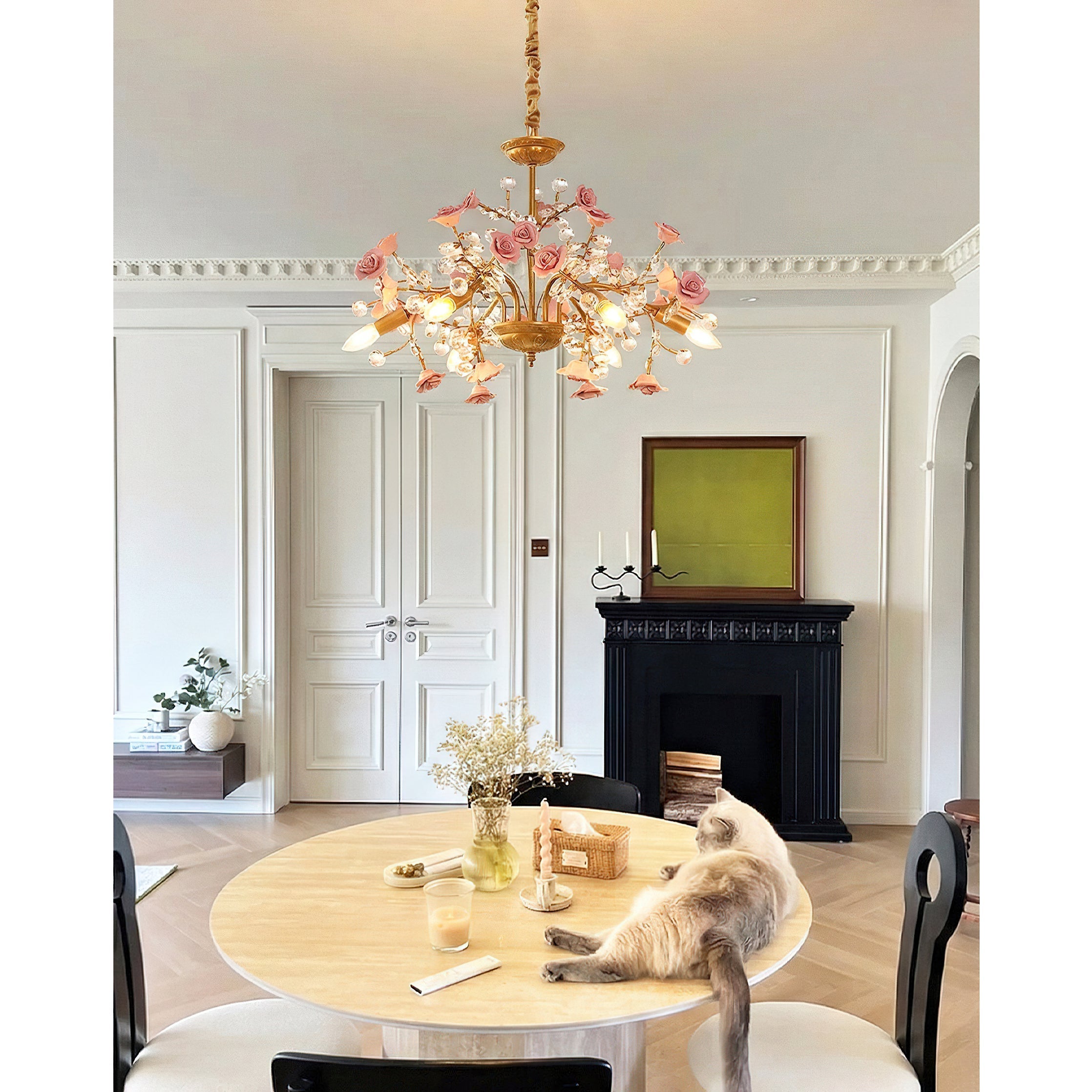 The Roseto Chandelier shown illuminated in a living room setting.