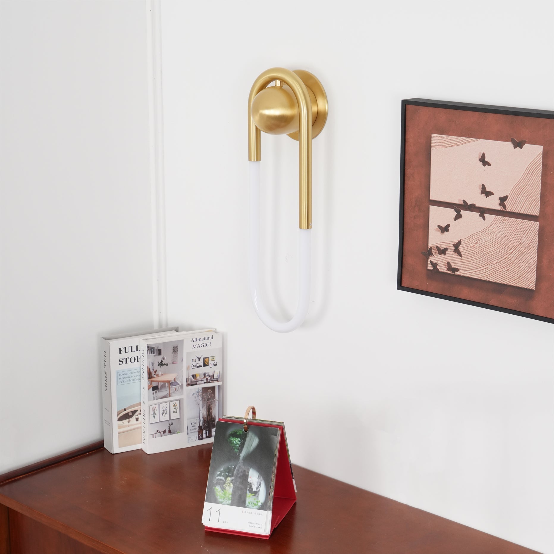 Comparison of the two available sizes of the Rudi Loop Wall Lamp.