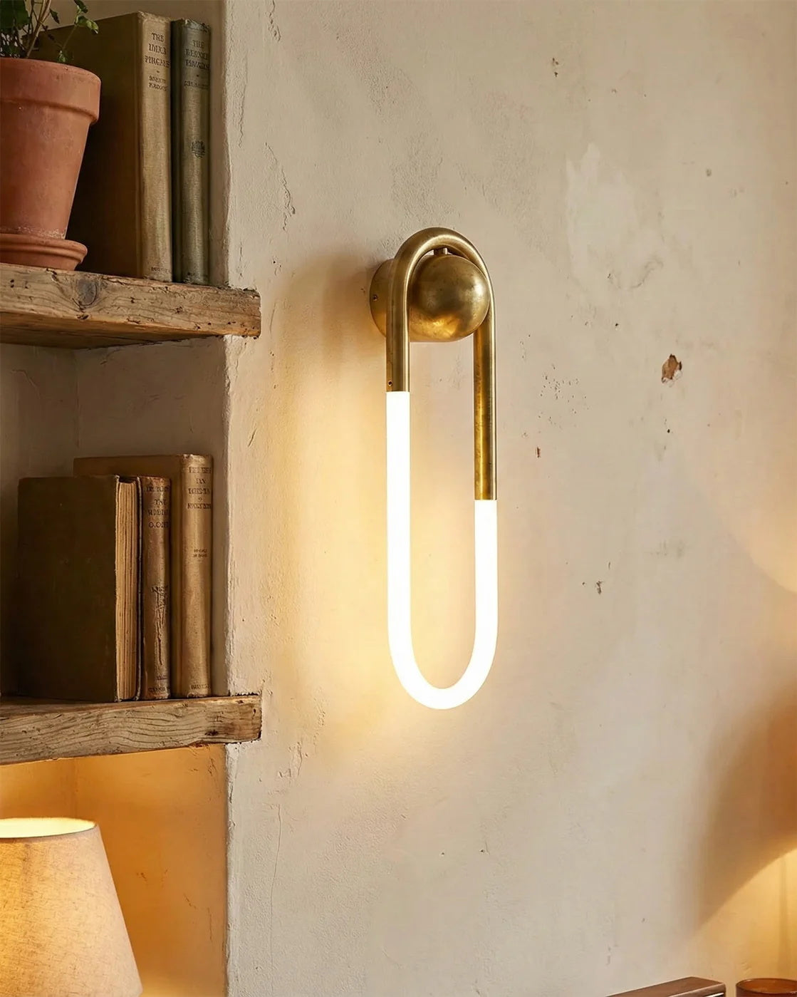 Close-up of the brass finish on the Rudi Loop Wall Lamp.