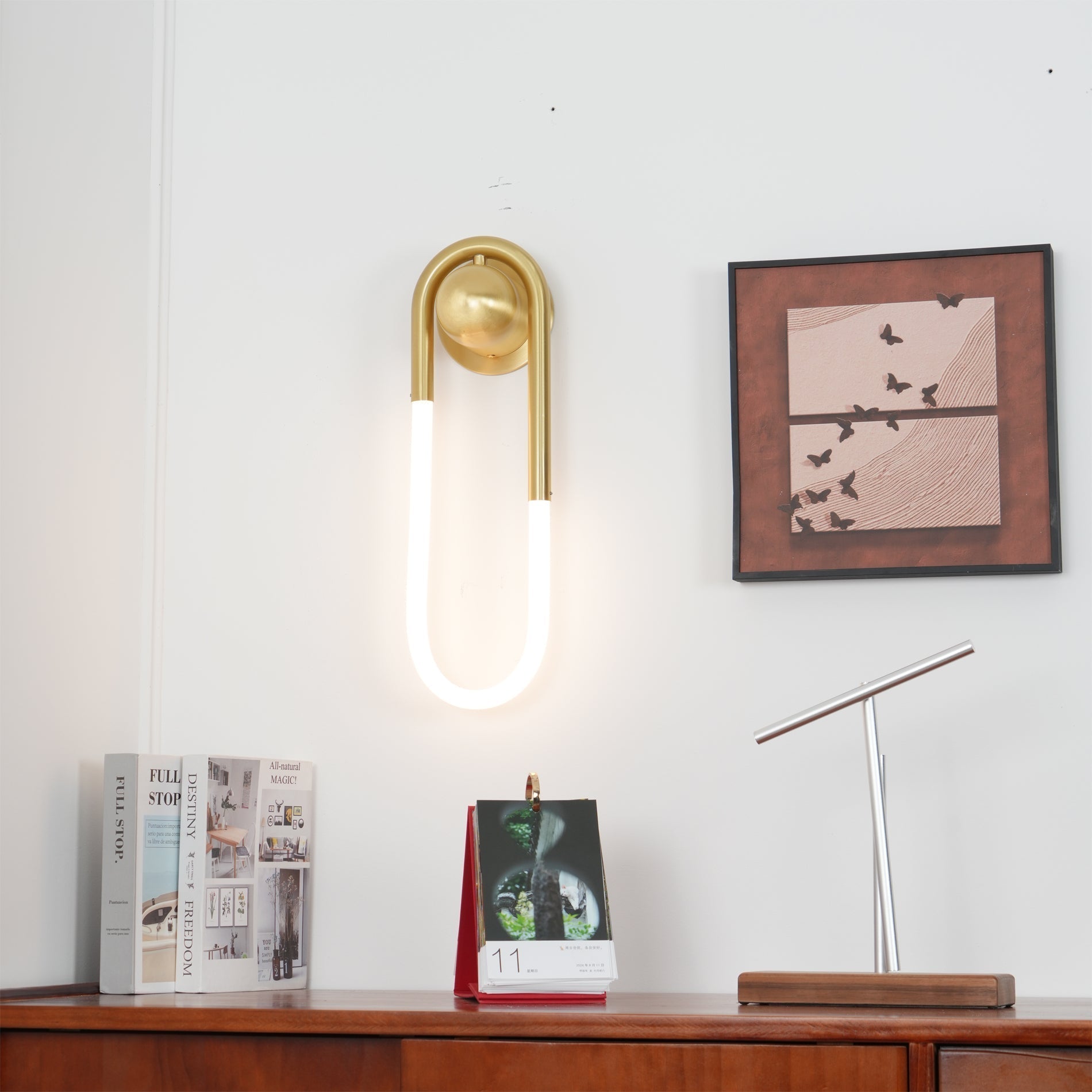 The smaller size Rudi Loop Wall Lamp next to a doorway.