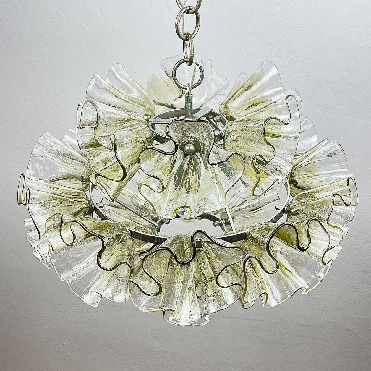 Ruffled Petal Glass Chandelier hanging in a luxury lounge.