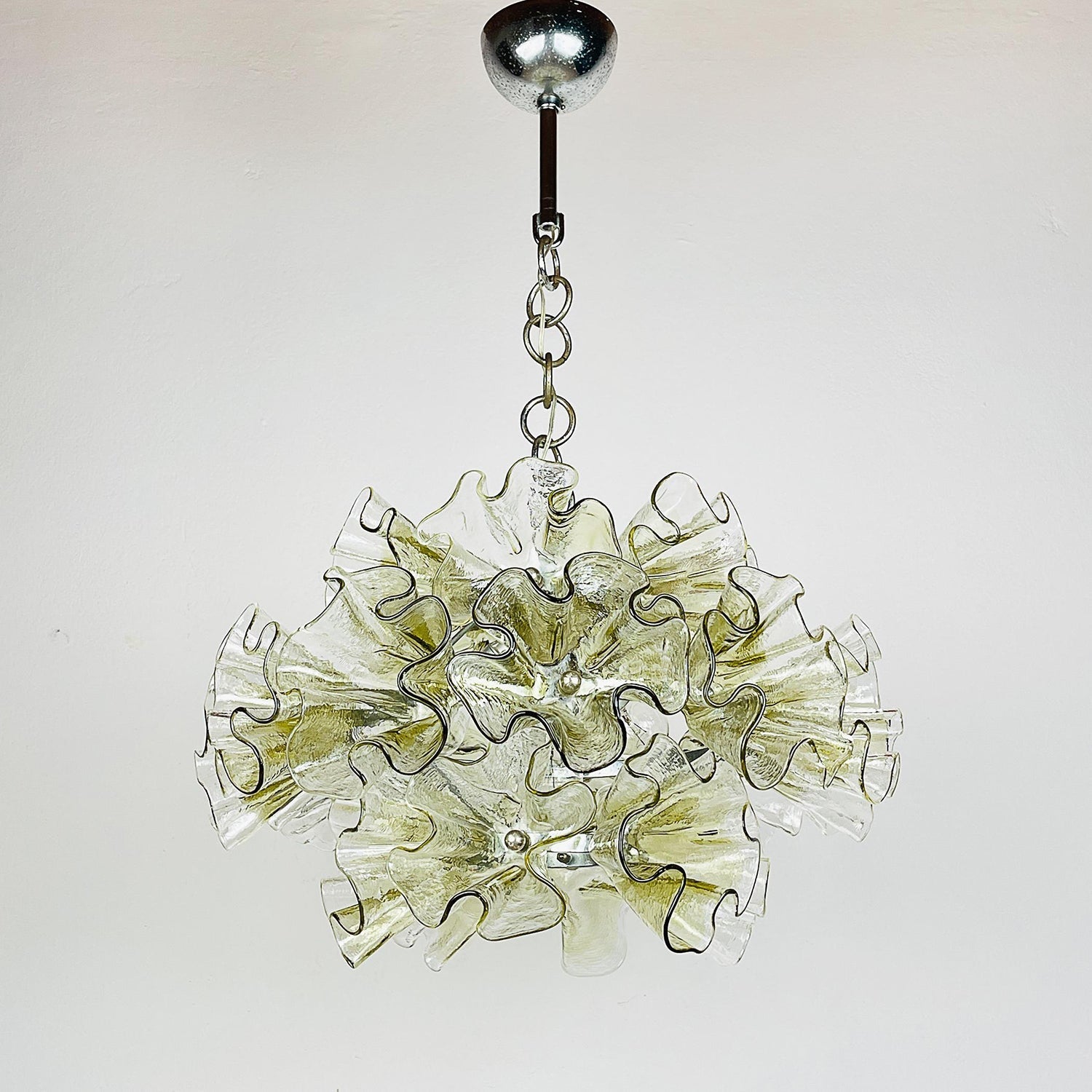 View of the chandelier from below, showing the light cluster.
