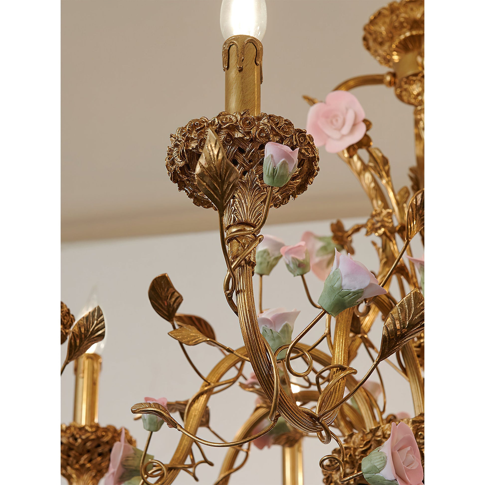 The full chandelier with its porcelain flowers and brass arms.