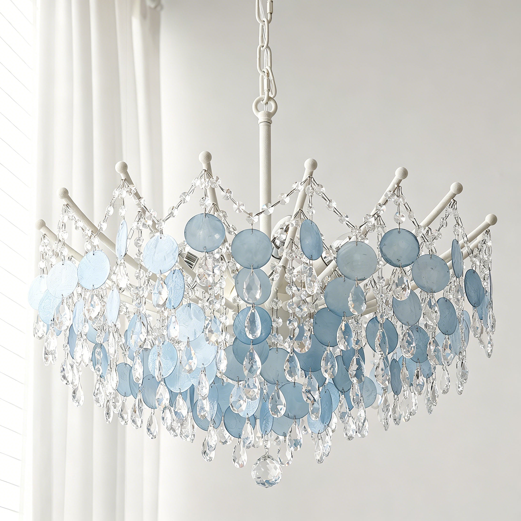 Close-up view of the tiered, natural capiz shells on the Sasha Chandelier.