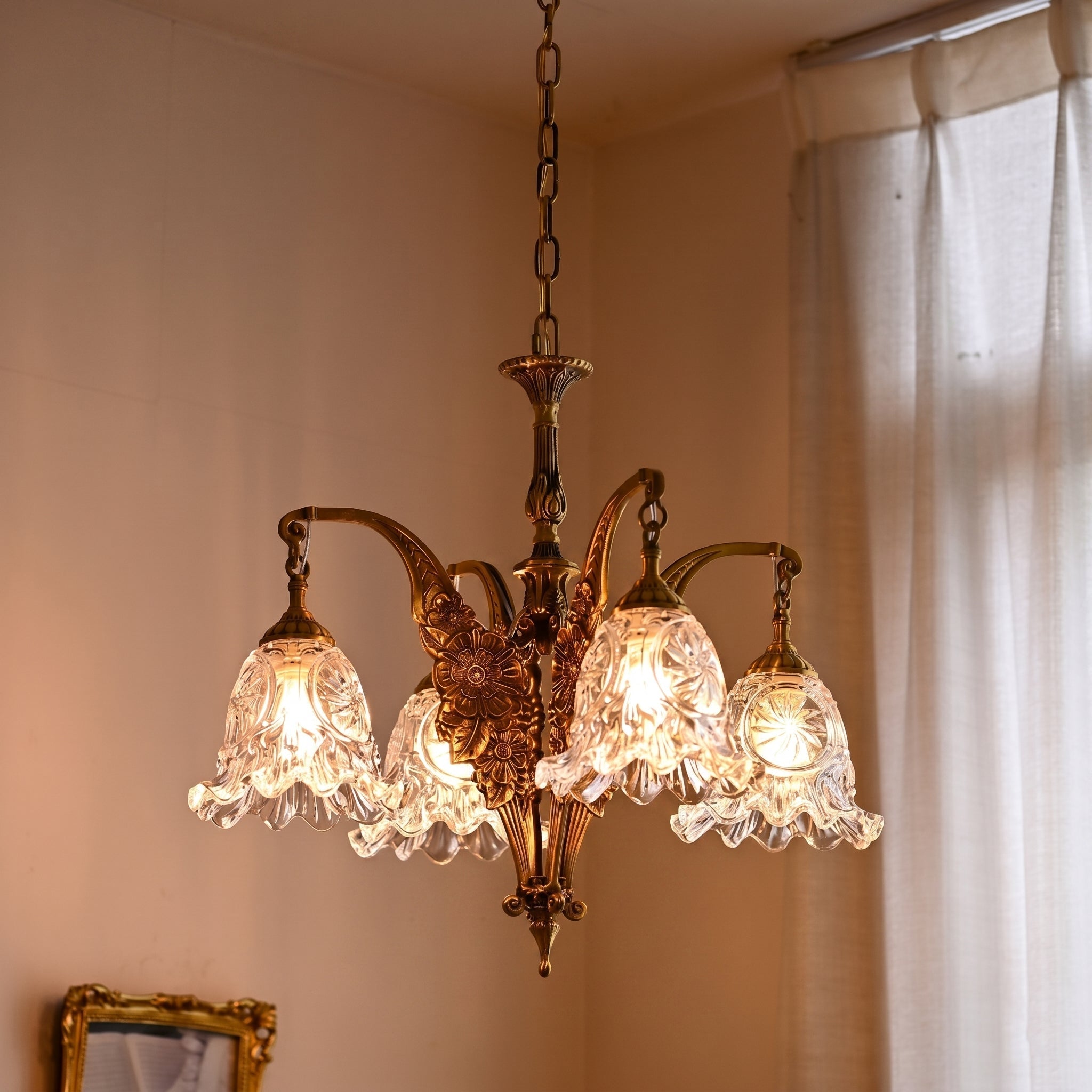 Detail shot of an amber glass bell-shaped shade, giving a warm hue.