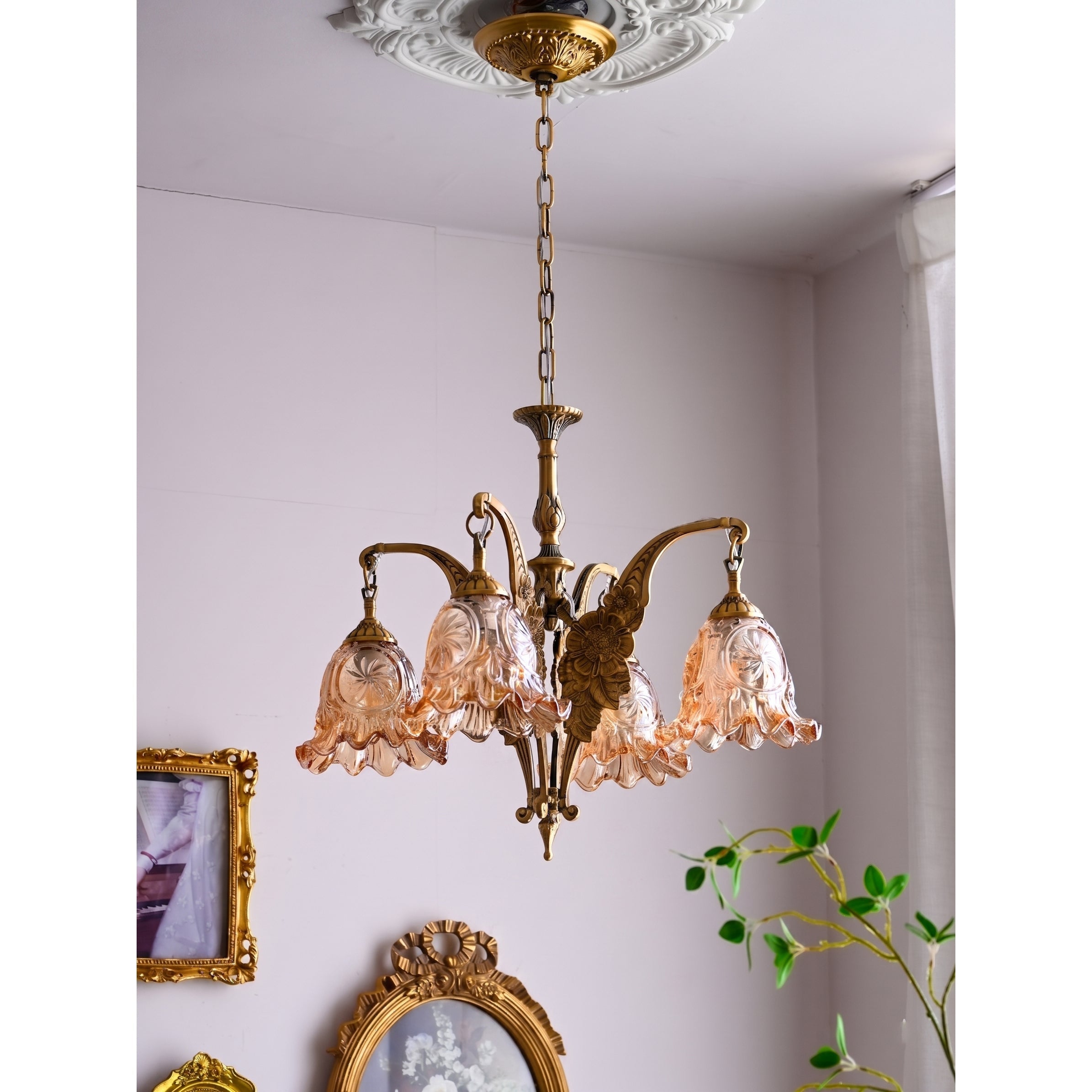The Savannah Bell Chandelier illuminated, casting a warm and inviting glow.