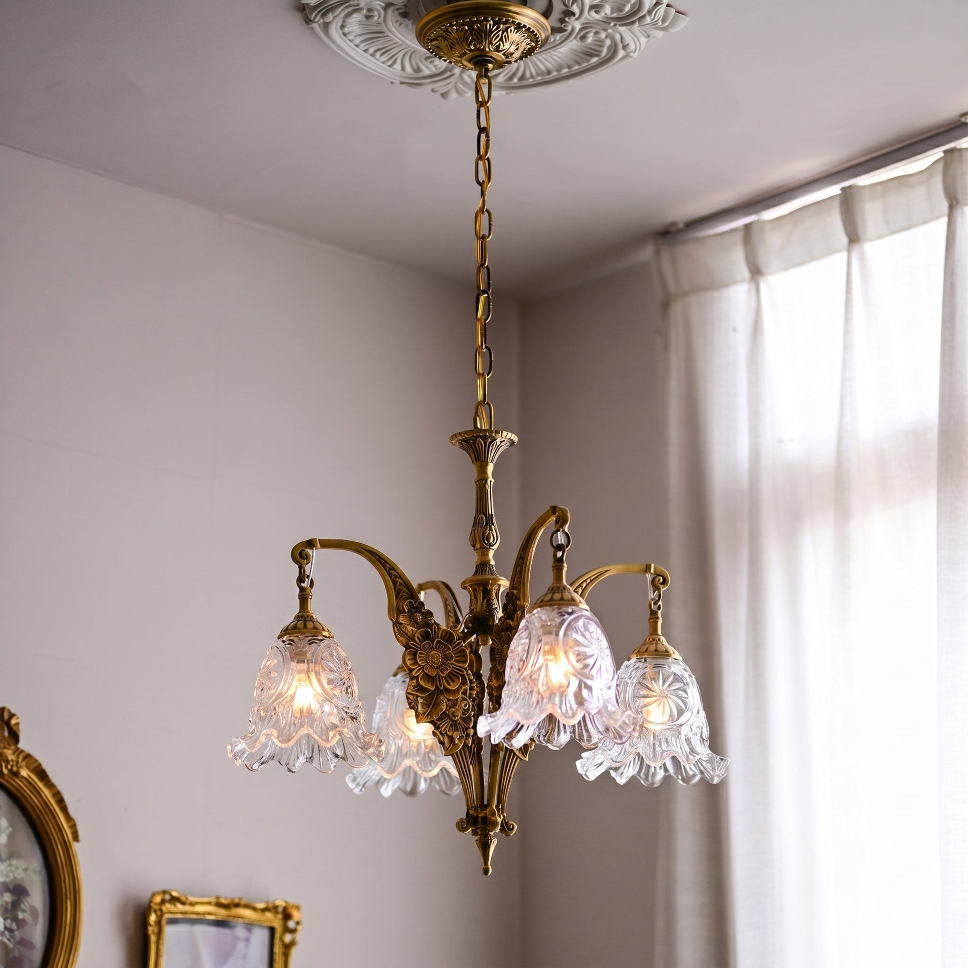 Detail shot of a clear glass bell-shaped shade on the chandelier.