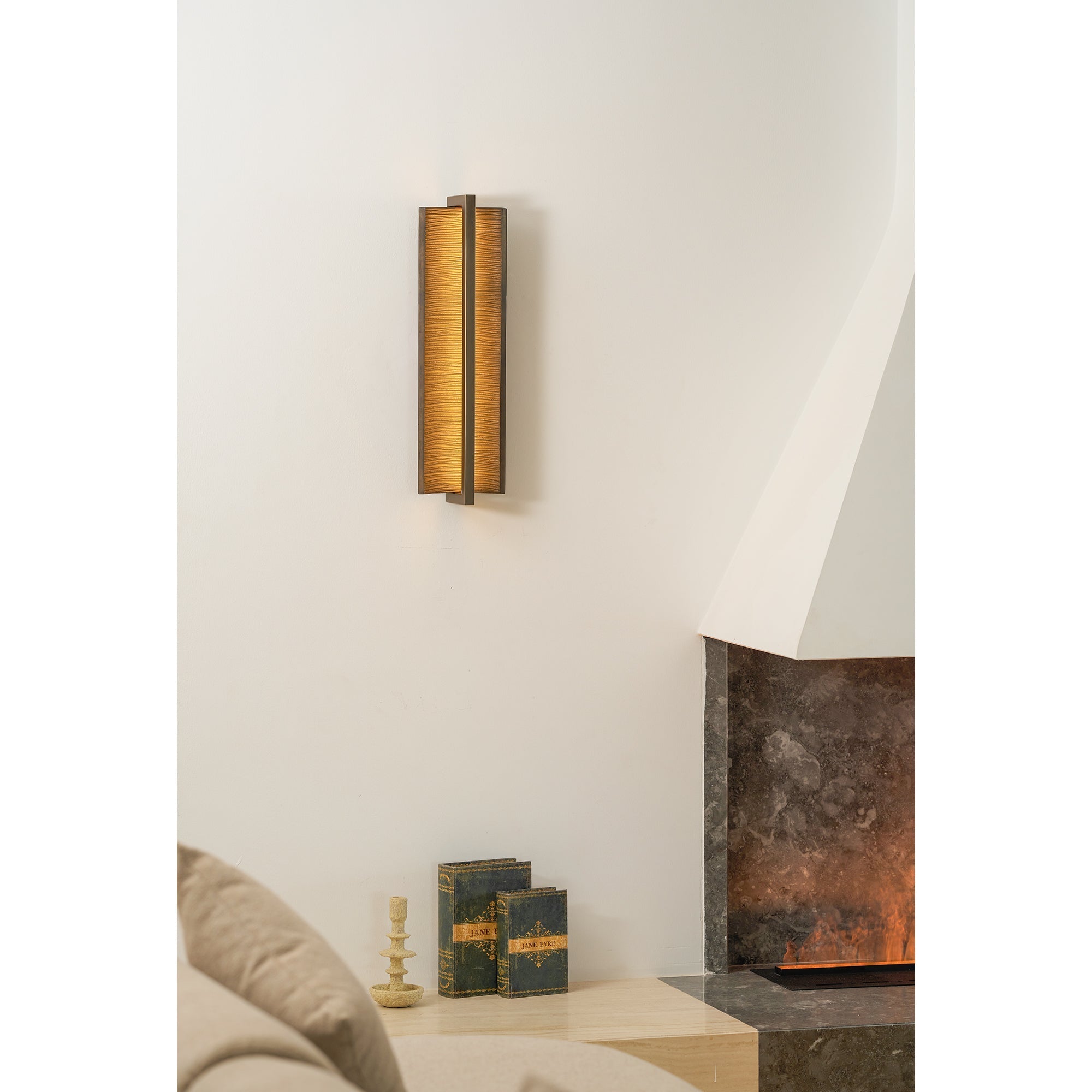 Lifestyle image featuring the Scorpio Wall Lamp above a side table.