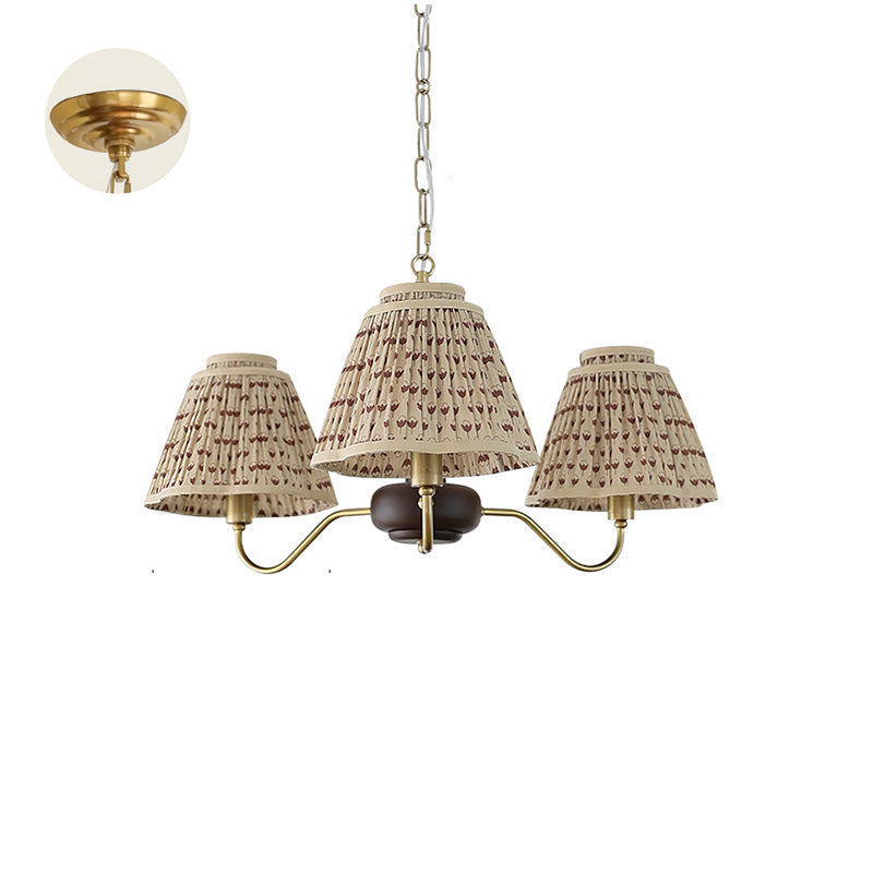 Lifestyle image of the Selva Chandelier hanging above a dining table.