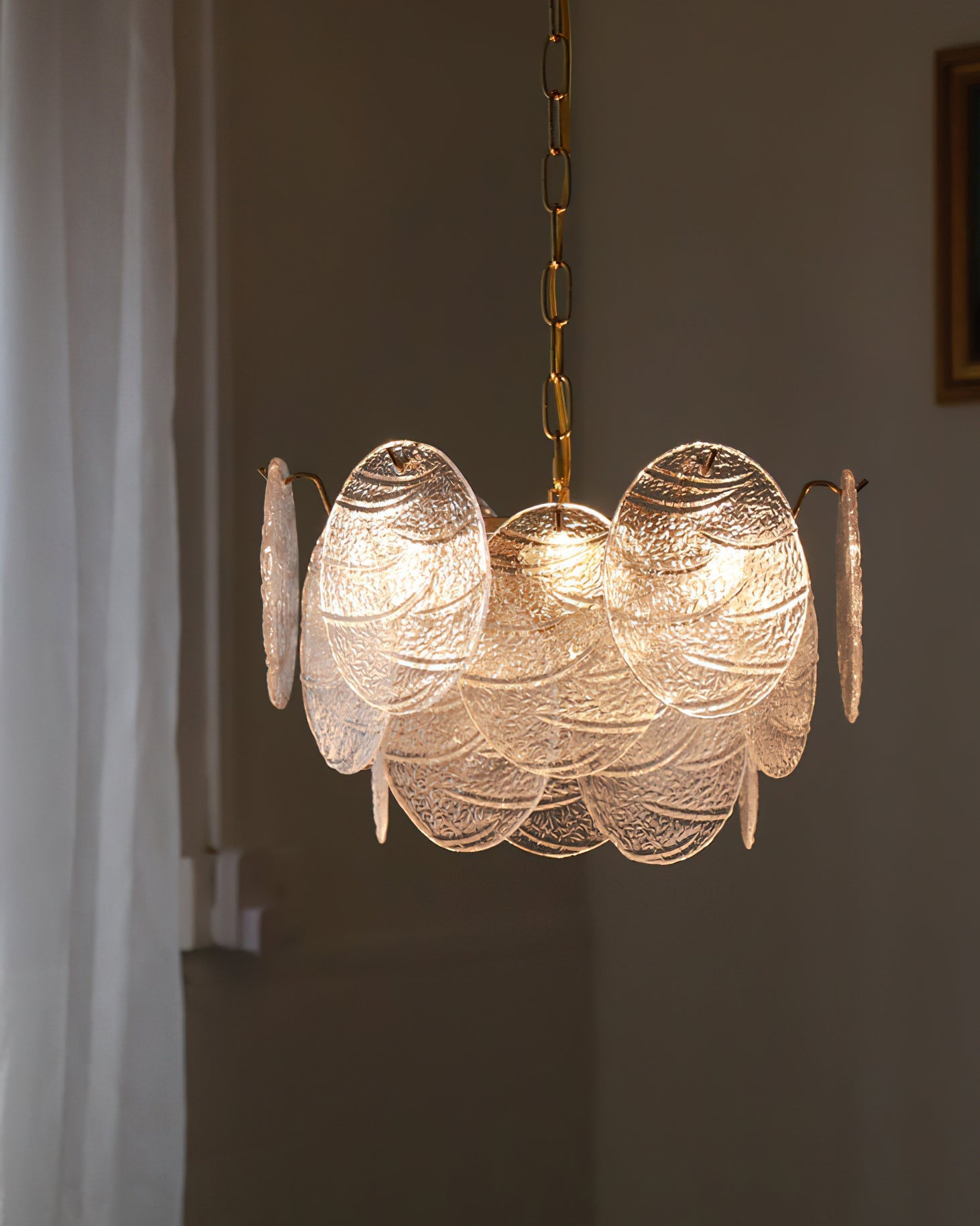 Bottom view of the chandelier showing the bulb placement within the glass halo.
