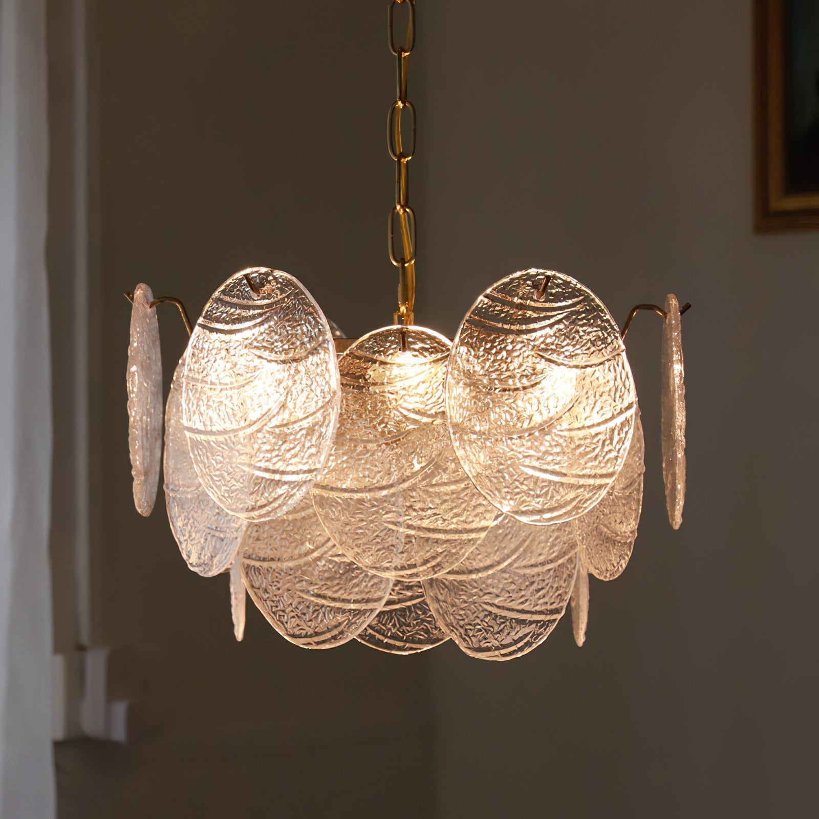 Seraphina Halo Chandelier illuminated in a dark room to show its ambient glow.