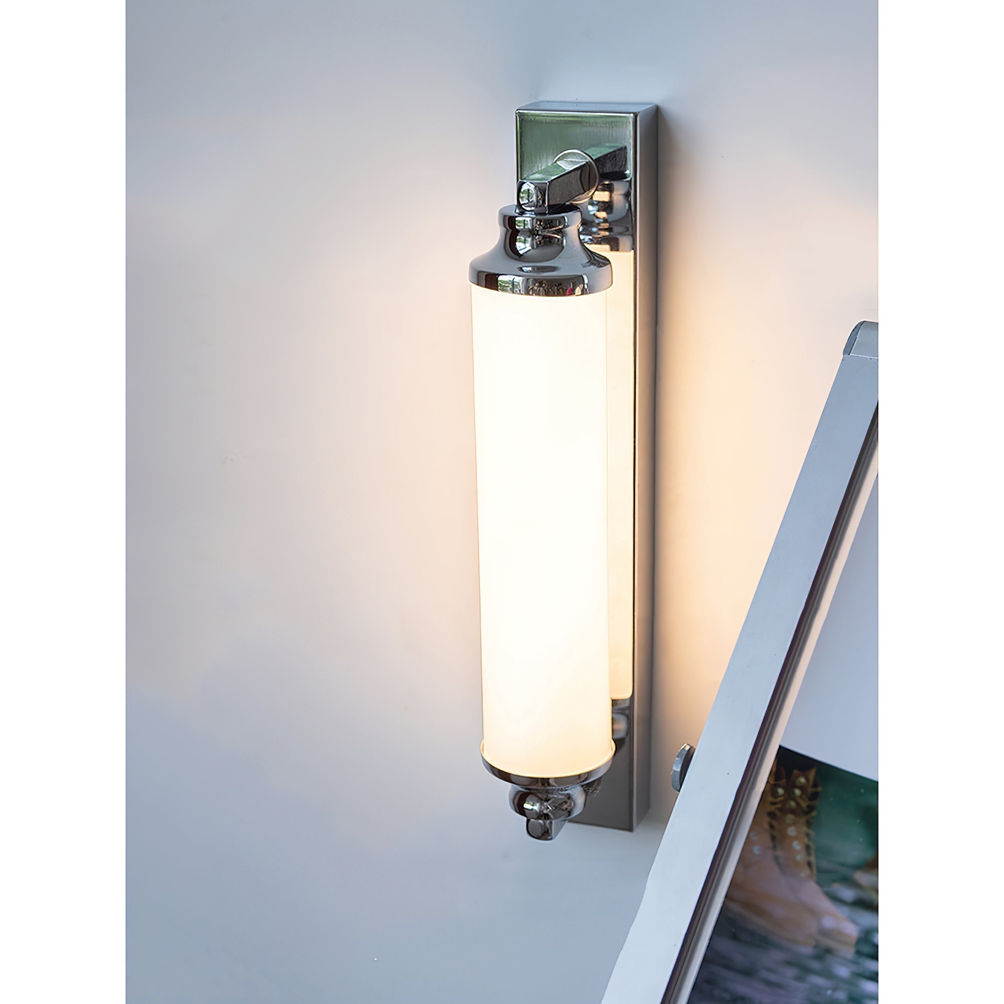 Sheridan Wall Lamp shown in a contemporary bathroom setting.
