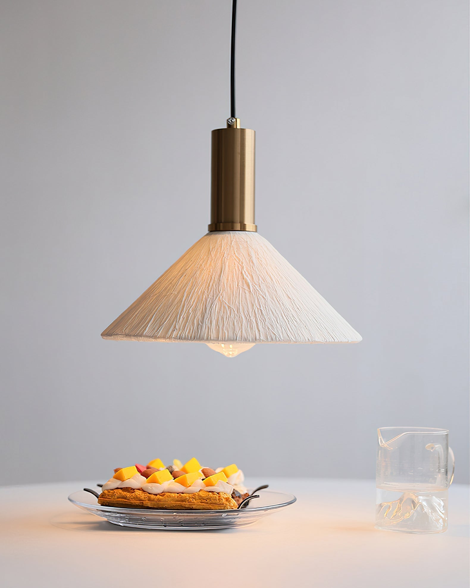 The Siya Pendant Light illuminated, casting a warm and inviting glow.