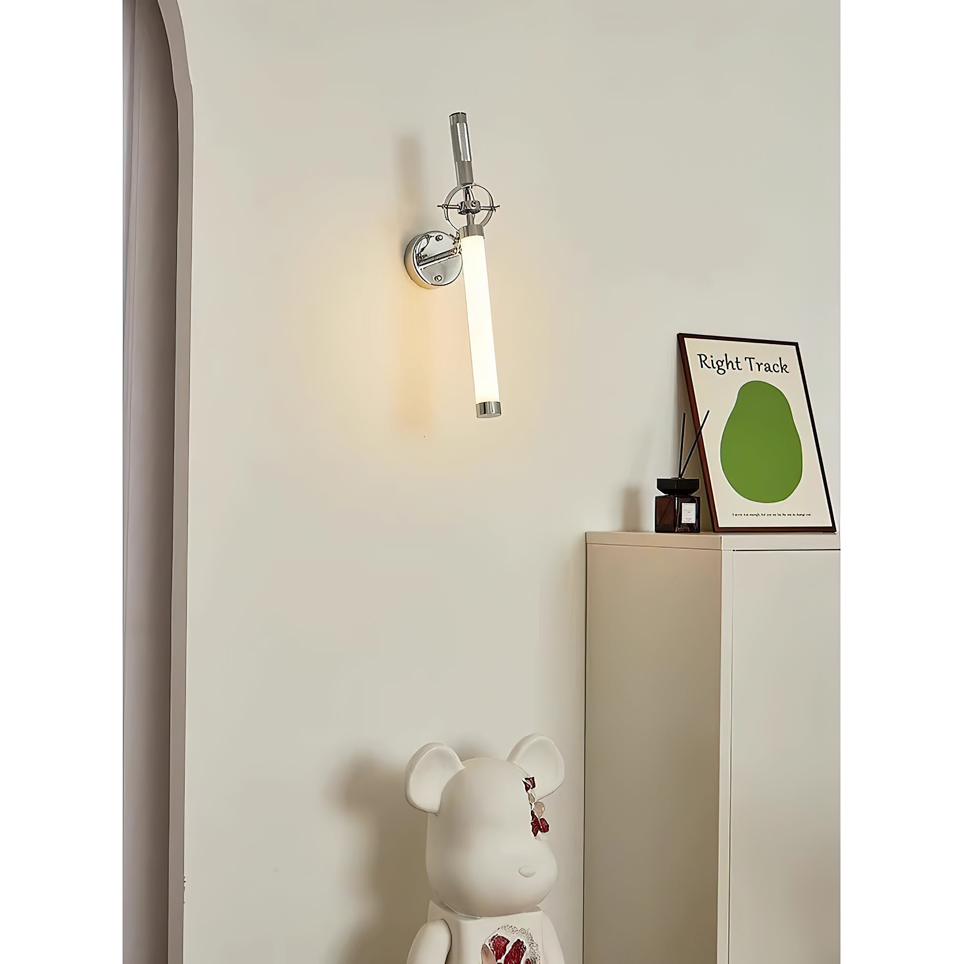 Lifestyle image of the Skylark Wall Lamp next to a piece of art.