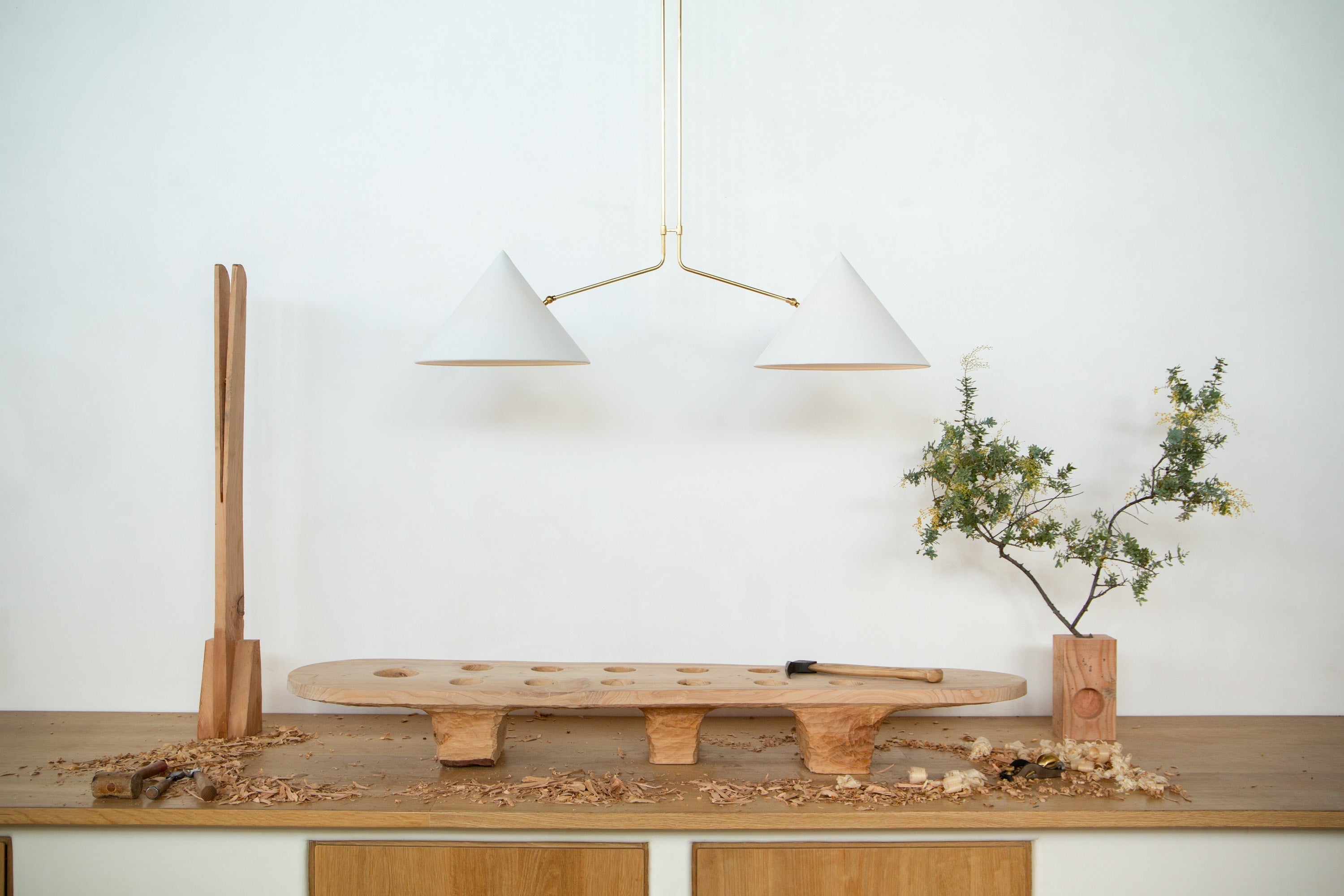 The Slide 2 Arm Pendant Lamp illuminated in a modern setting.