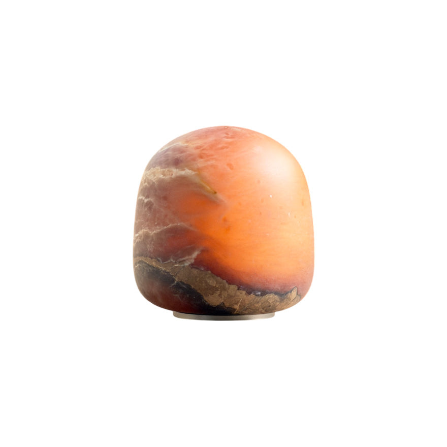 Alabaster Petite Portable Lamp with a soft white glow on a wooden surface.
