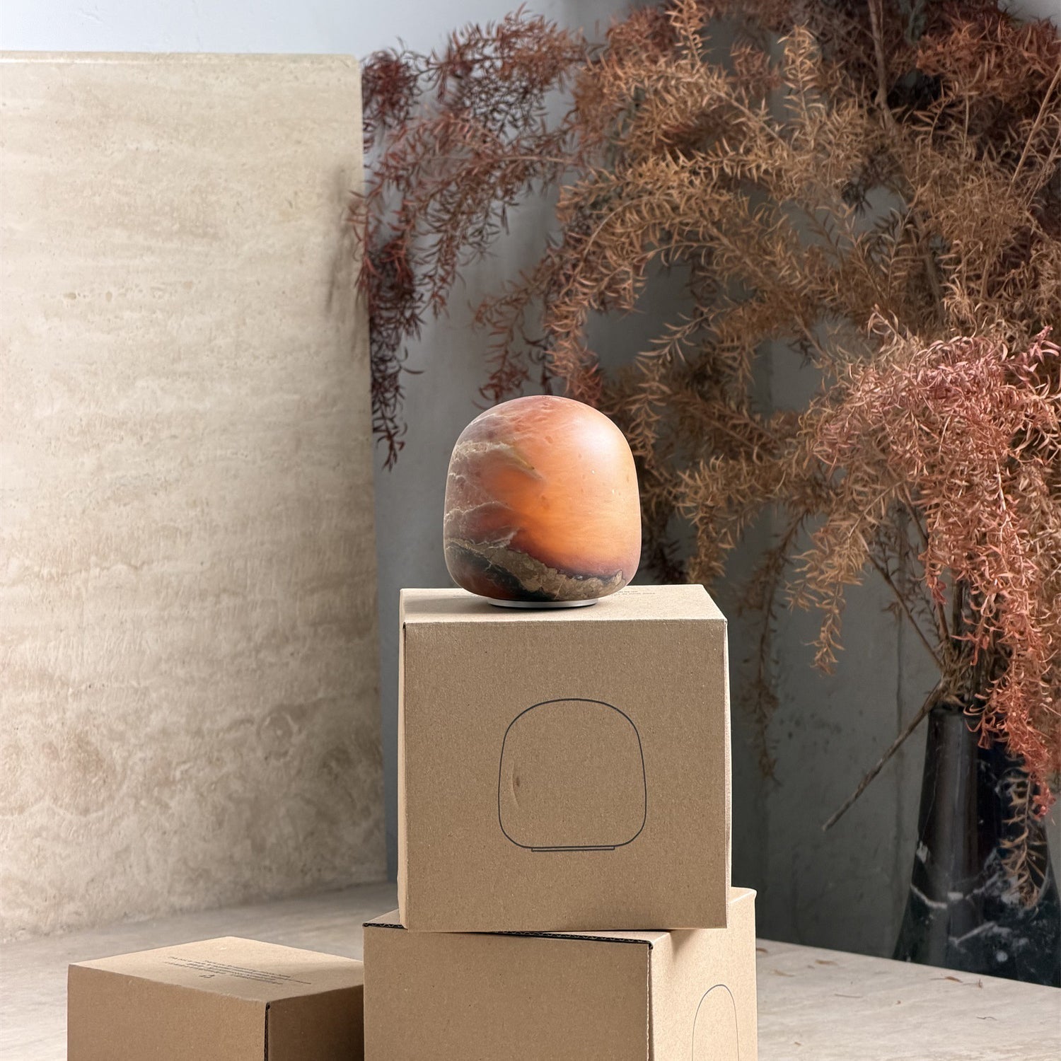 The alabaster lamp casting a soft light on a dark background.