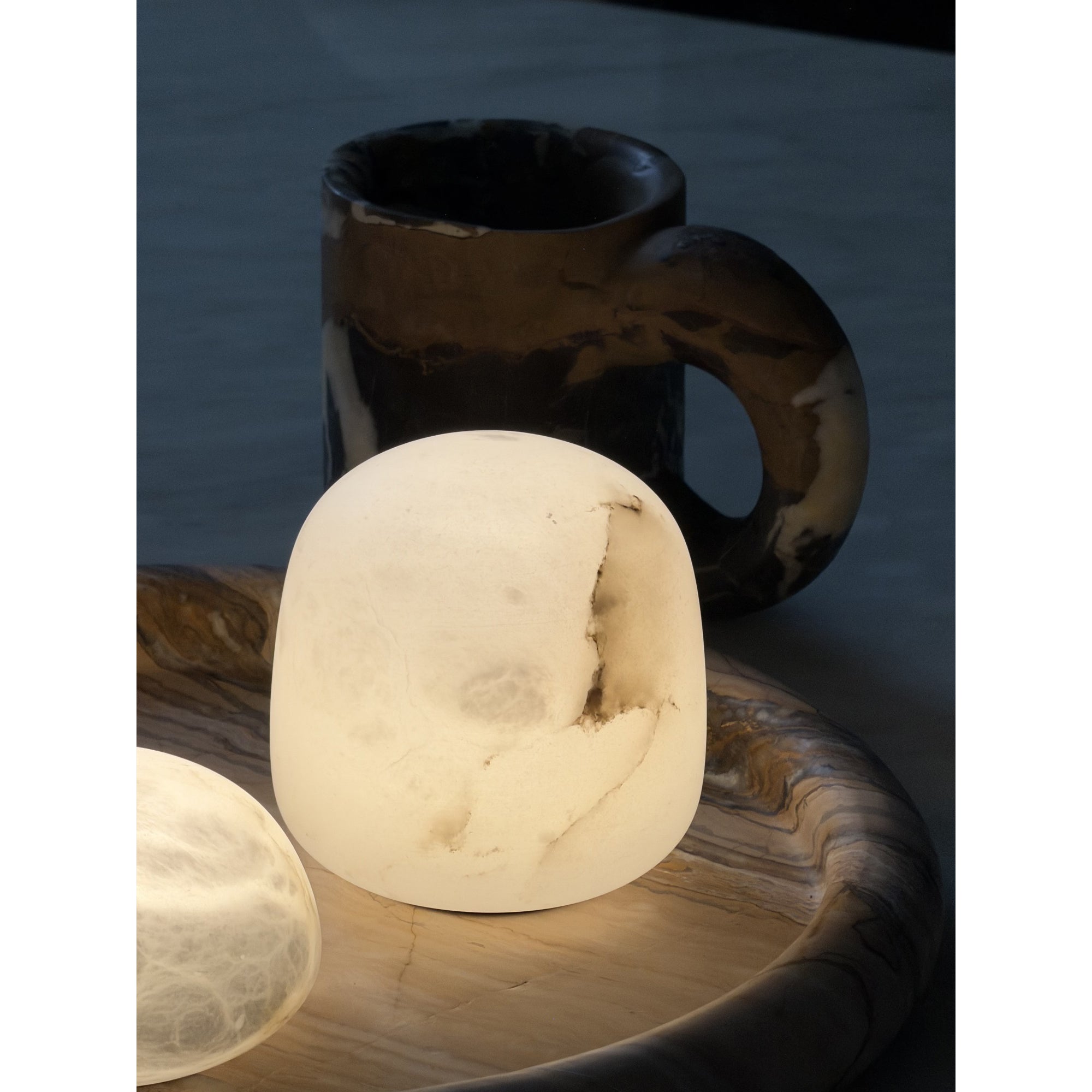 The lamp placed in a minimalist bedroom setting.