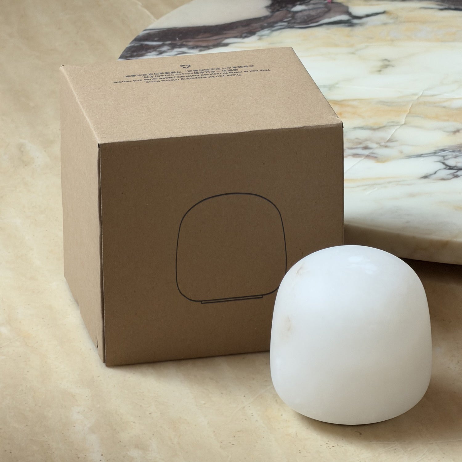 The alabaster lamp displayed with its included USB charging cable.