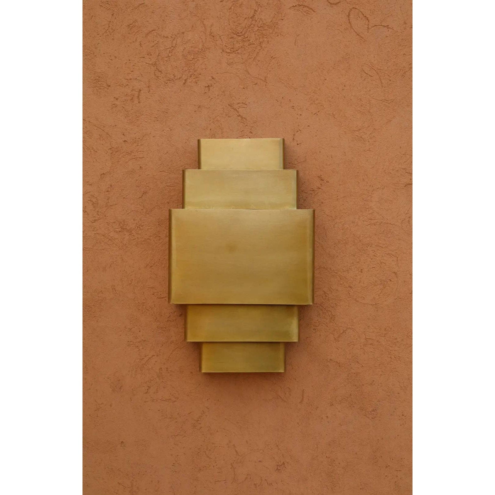 The warm light cast by the Sofia Brass Wall Lamp.