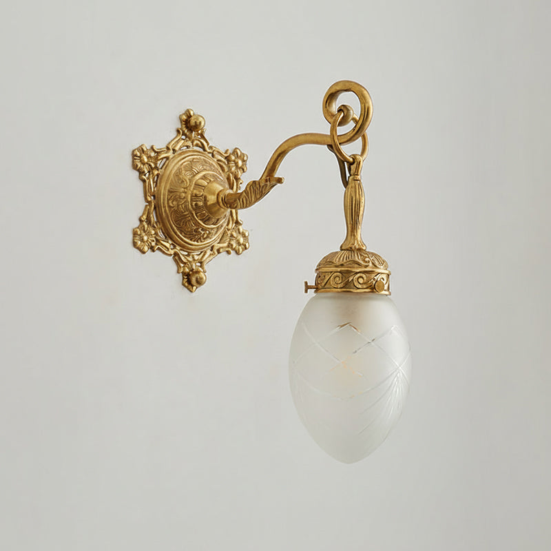 Solange wall lamp illuminated, casting a warm glow.