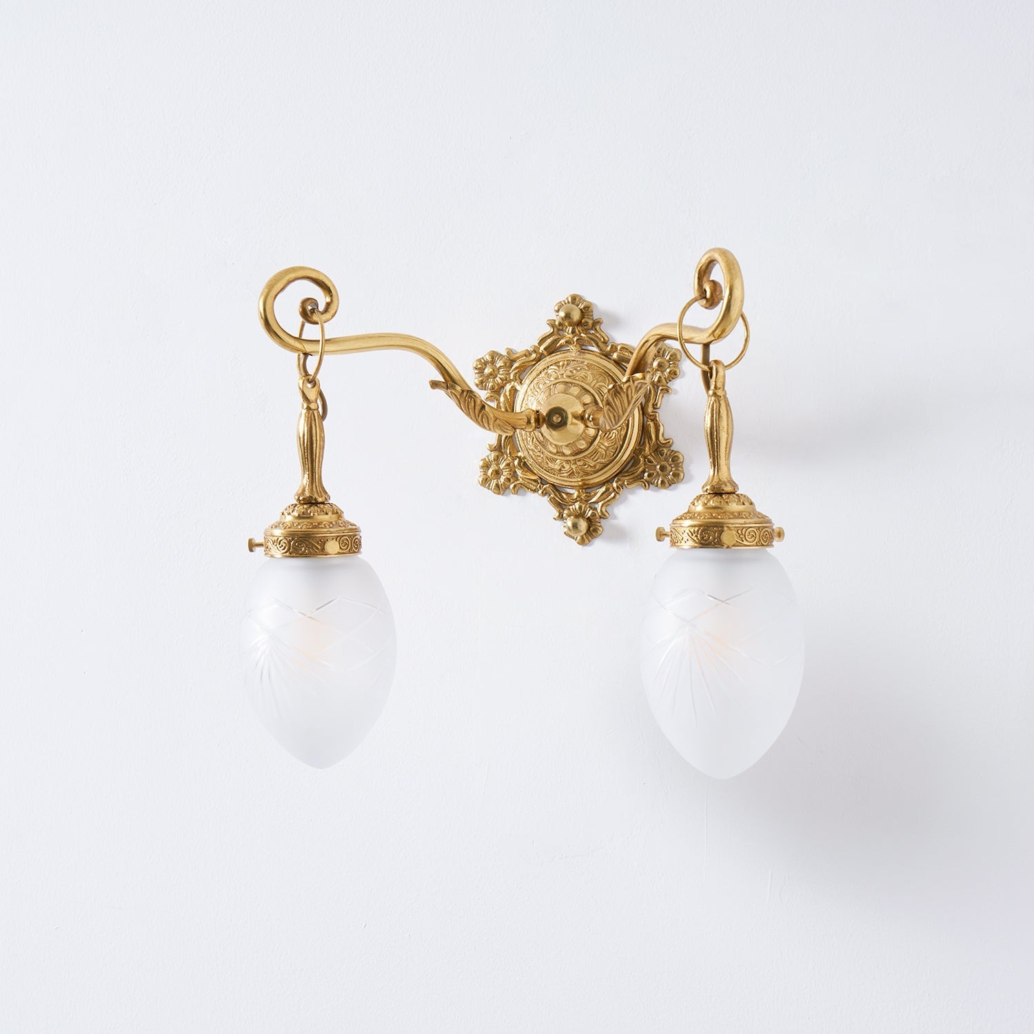 The Solange wall lamp shown against a dark wall for contrast.