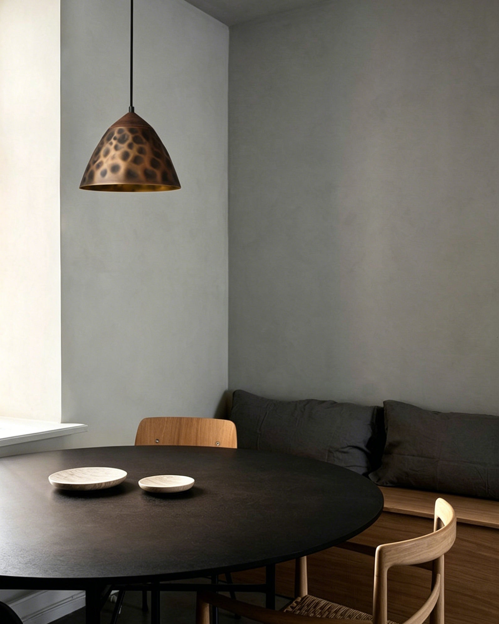A row of Boyd Brass Pendant Lamps hanging over a modern kitchen island.