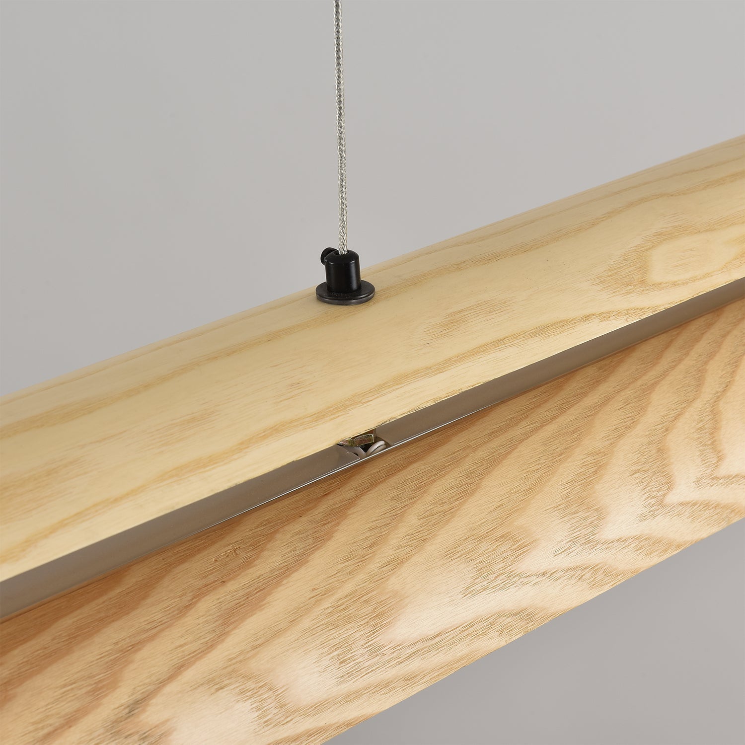 A wide shot of the Sora Linear Chandelier in a spacious living area.
