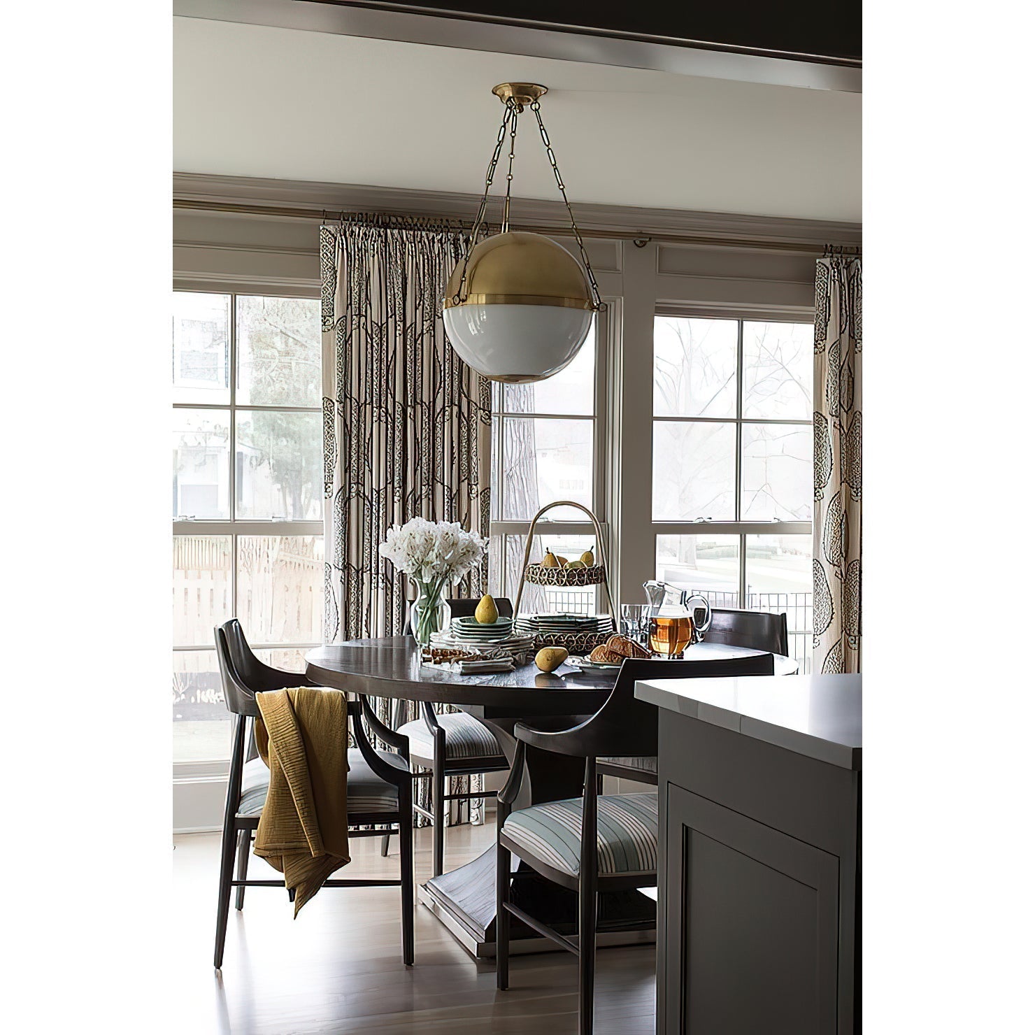A pair of Sphere No.2 Pendant Lamps hanging over a kitchen island.