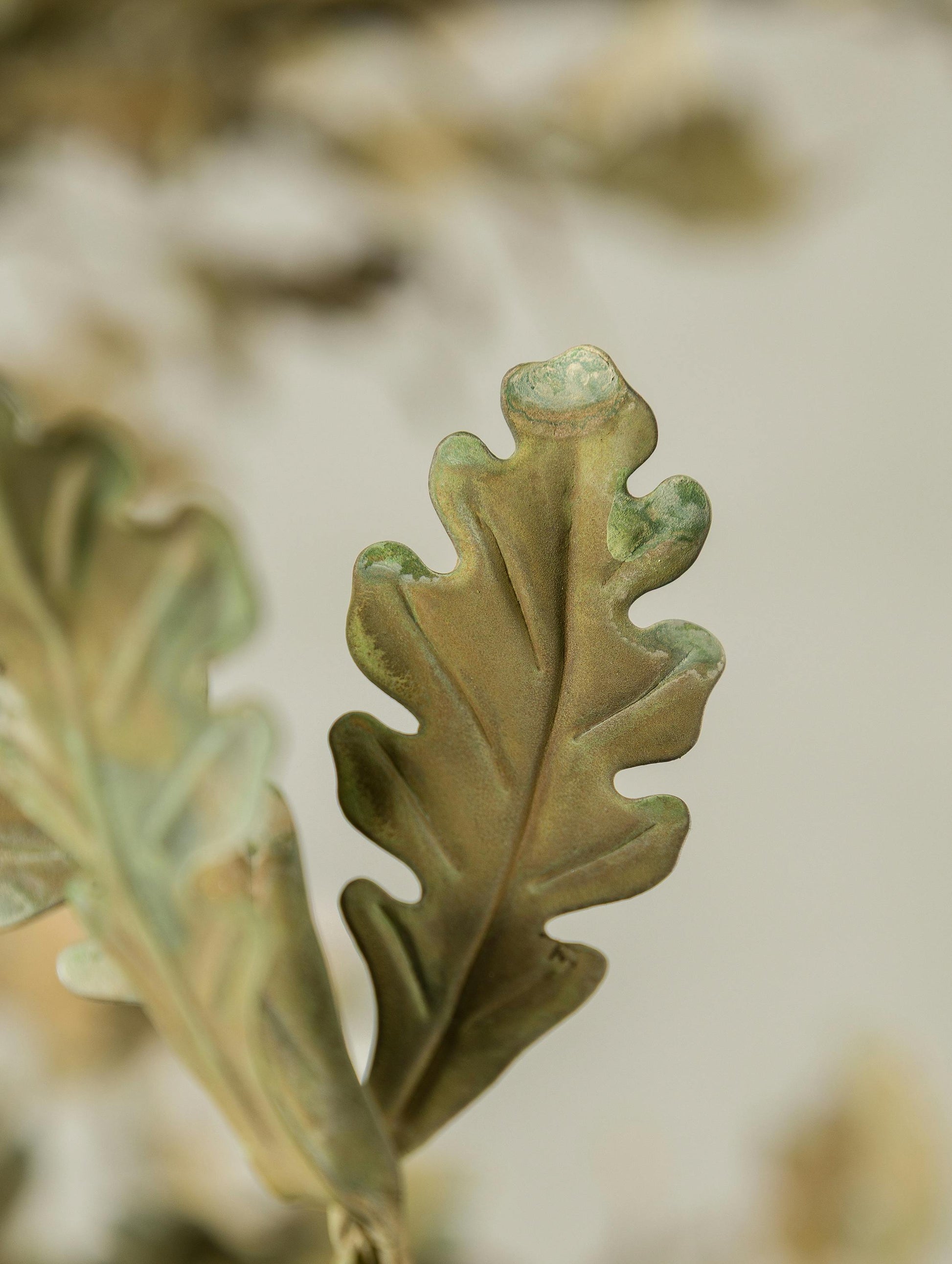 The hand-aged iron finish of the Spring Oak Tree Chandelier.