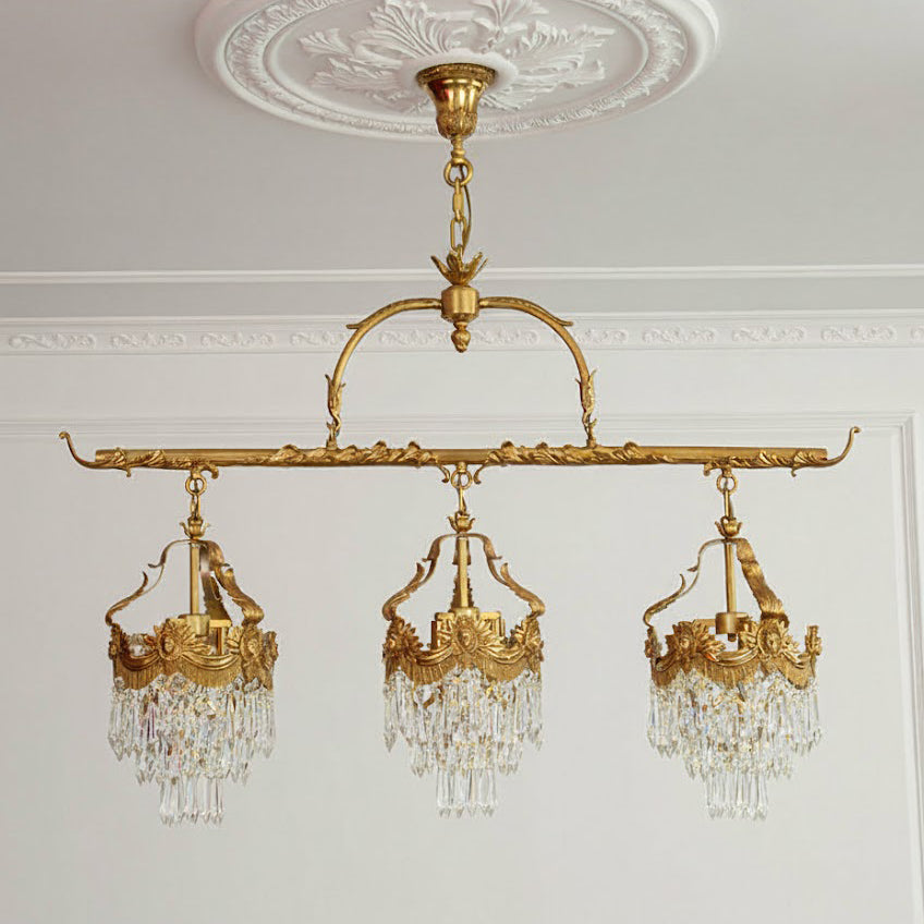 The 3-head lamp illuminating a long dining table.