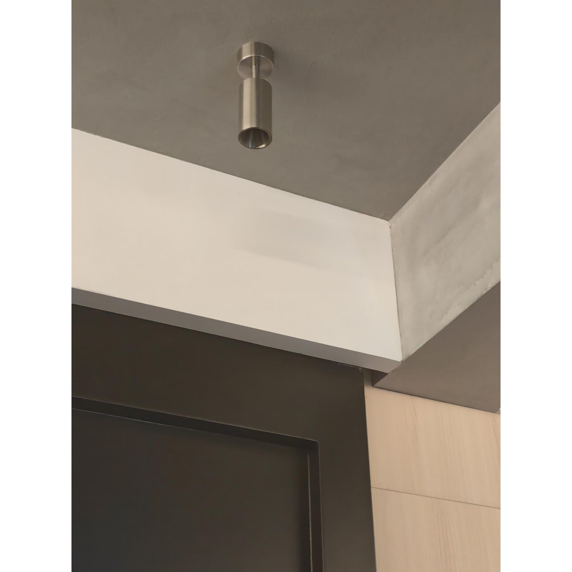 Stanly Ceiling Spotlight Lamp in nickel, highlighting artwork on a wall.