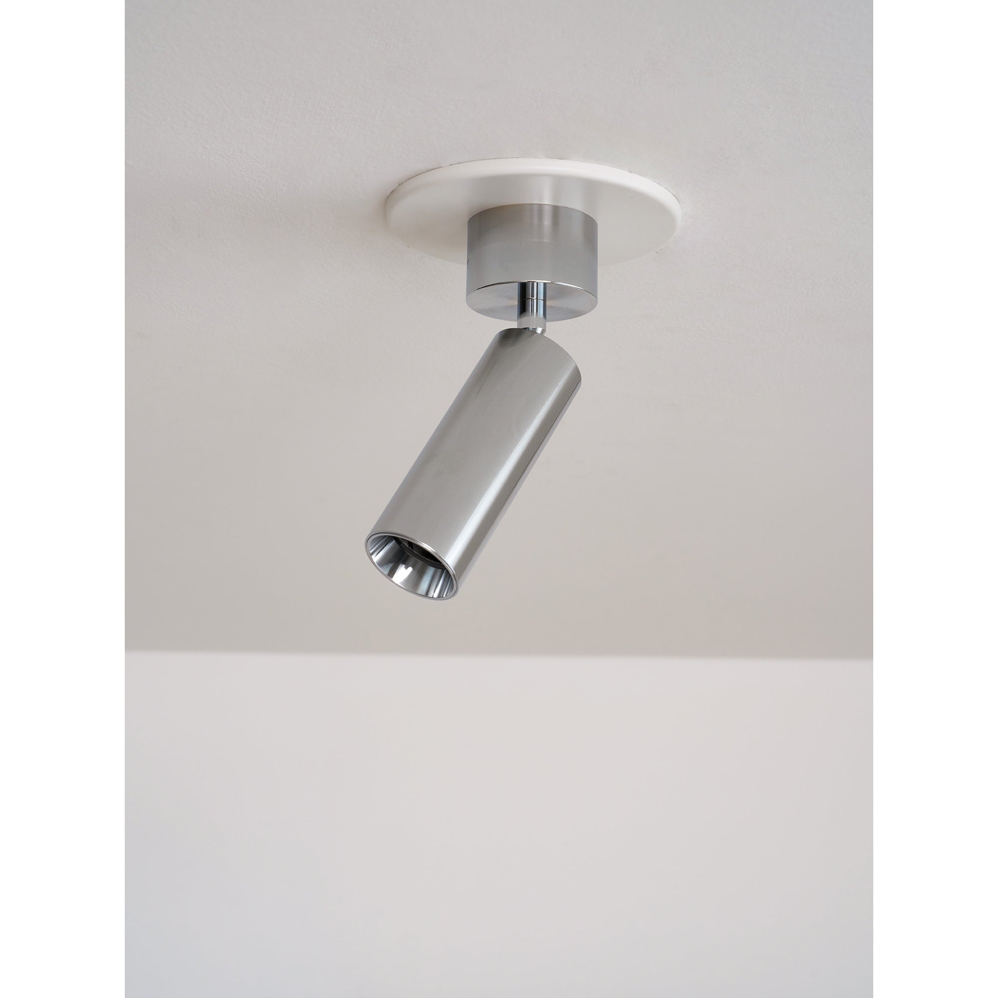 Stanly spotlight in gray finish, installed in a hallway.