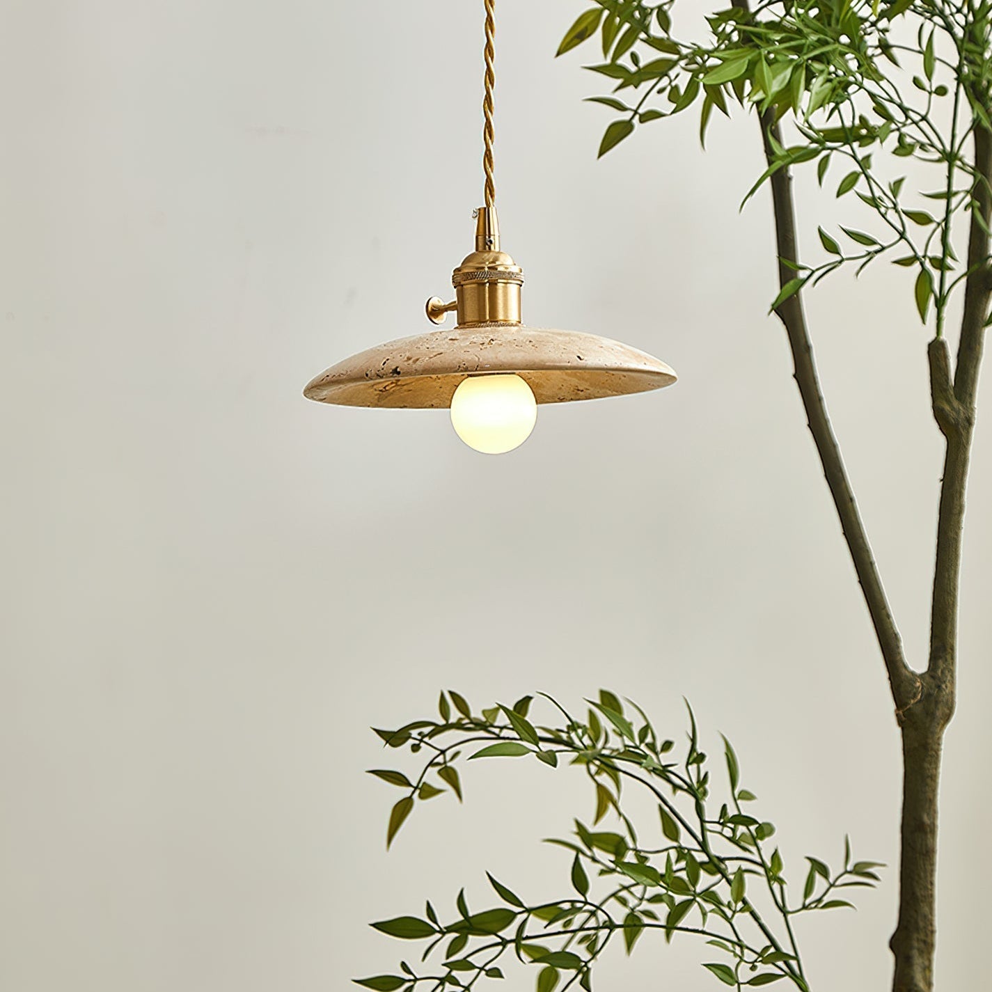 Close-up view of the textured travertine stone on the Stella Pendant Light.