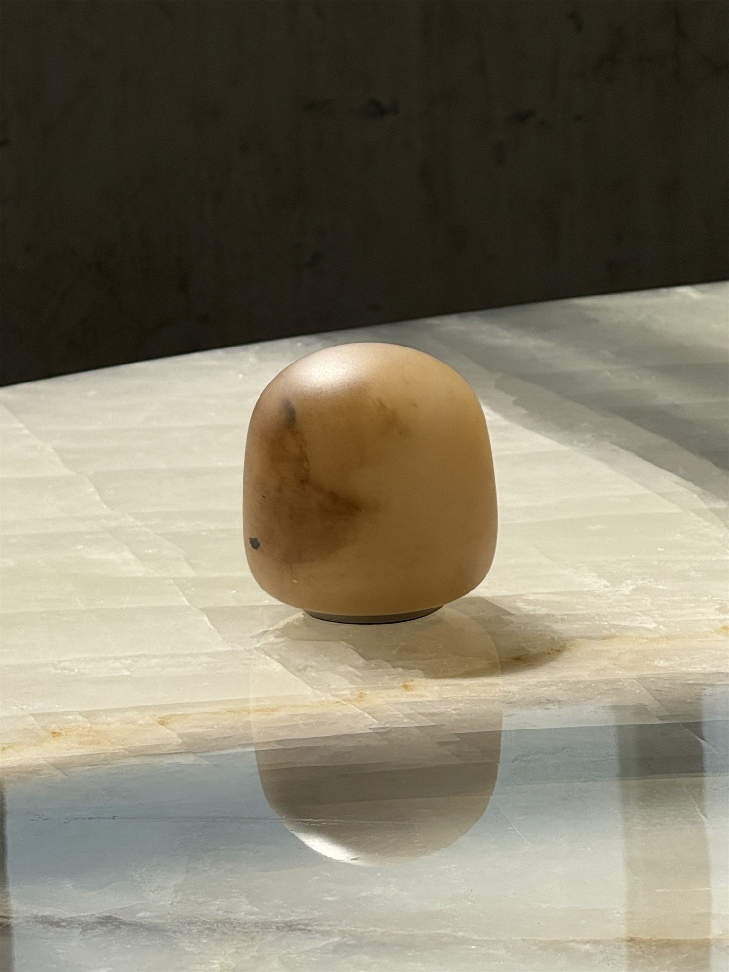 Angled view of the tall alabaster lamp.
