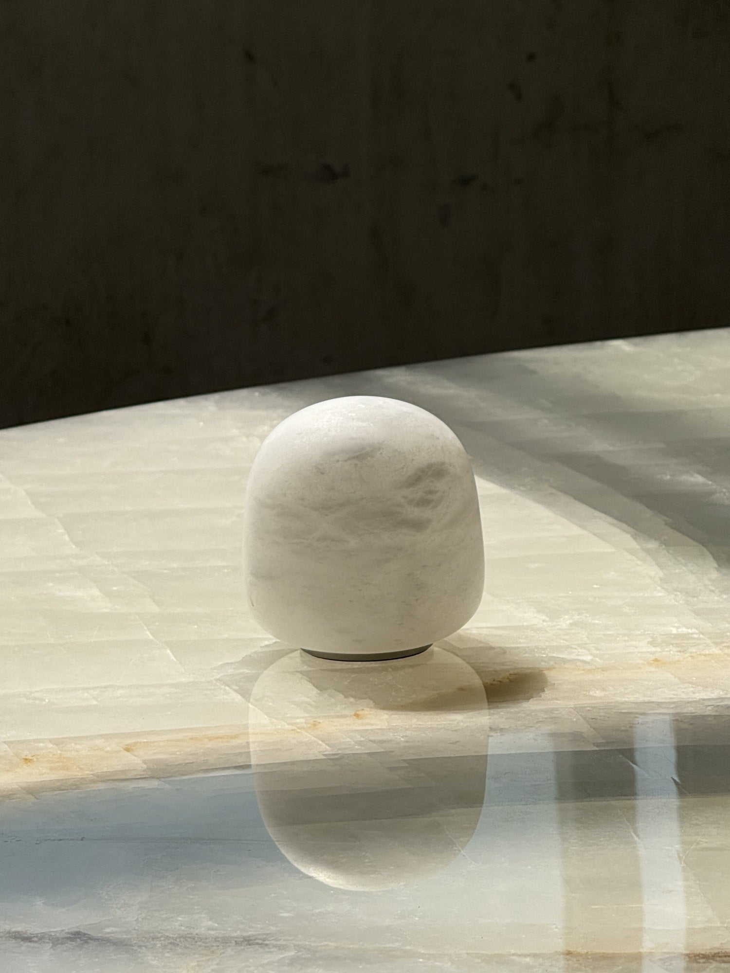 The lamp's soft glow reflecting on a surface.