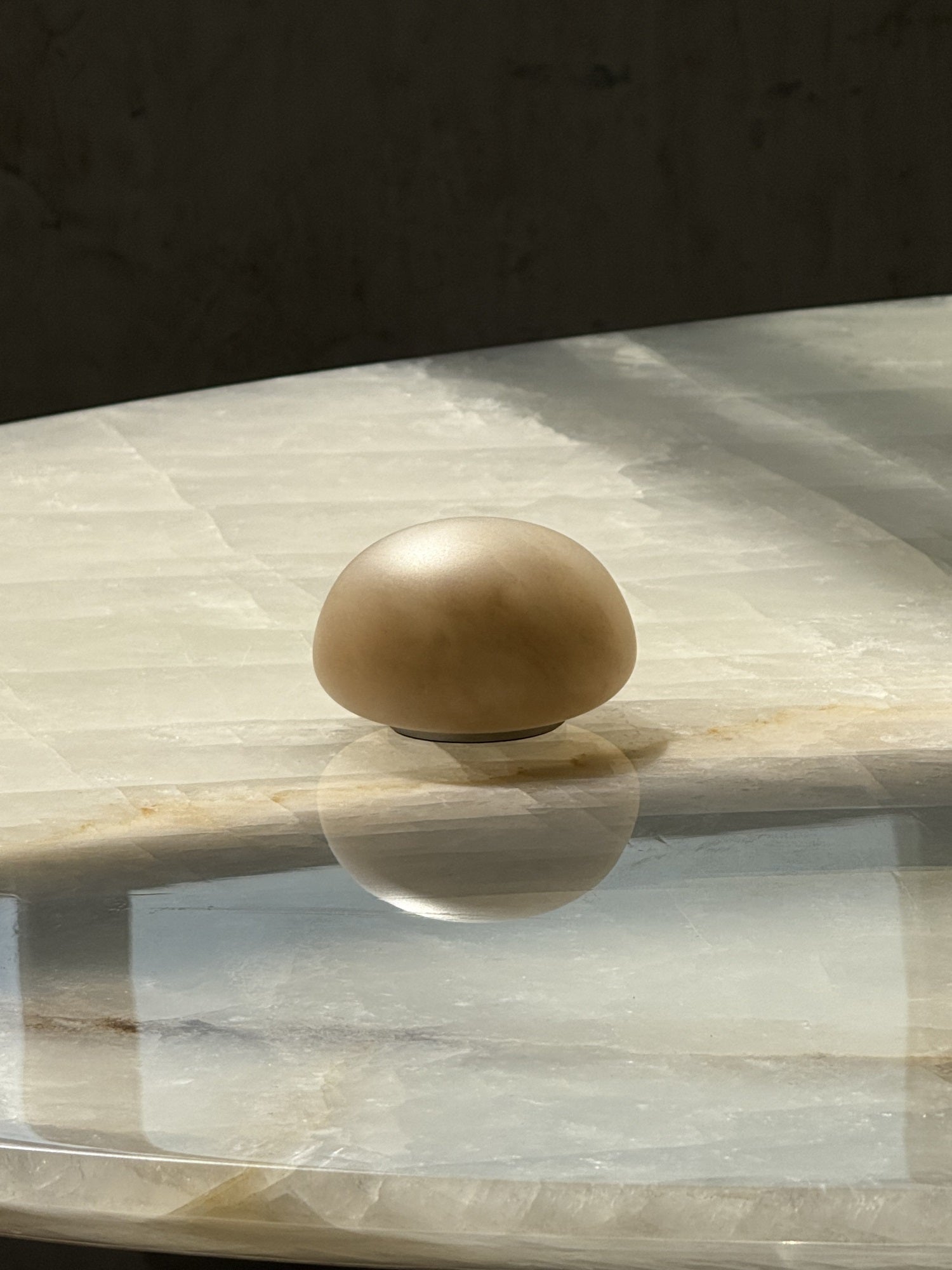 Angled view of the short alabaster lamp.
